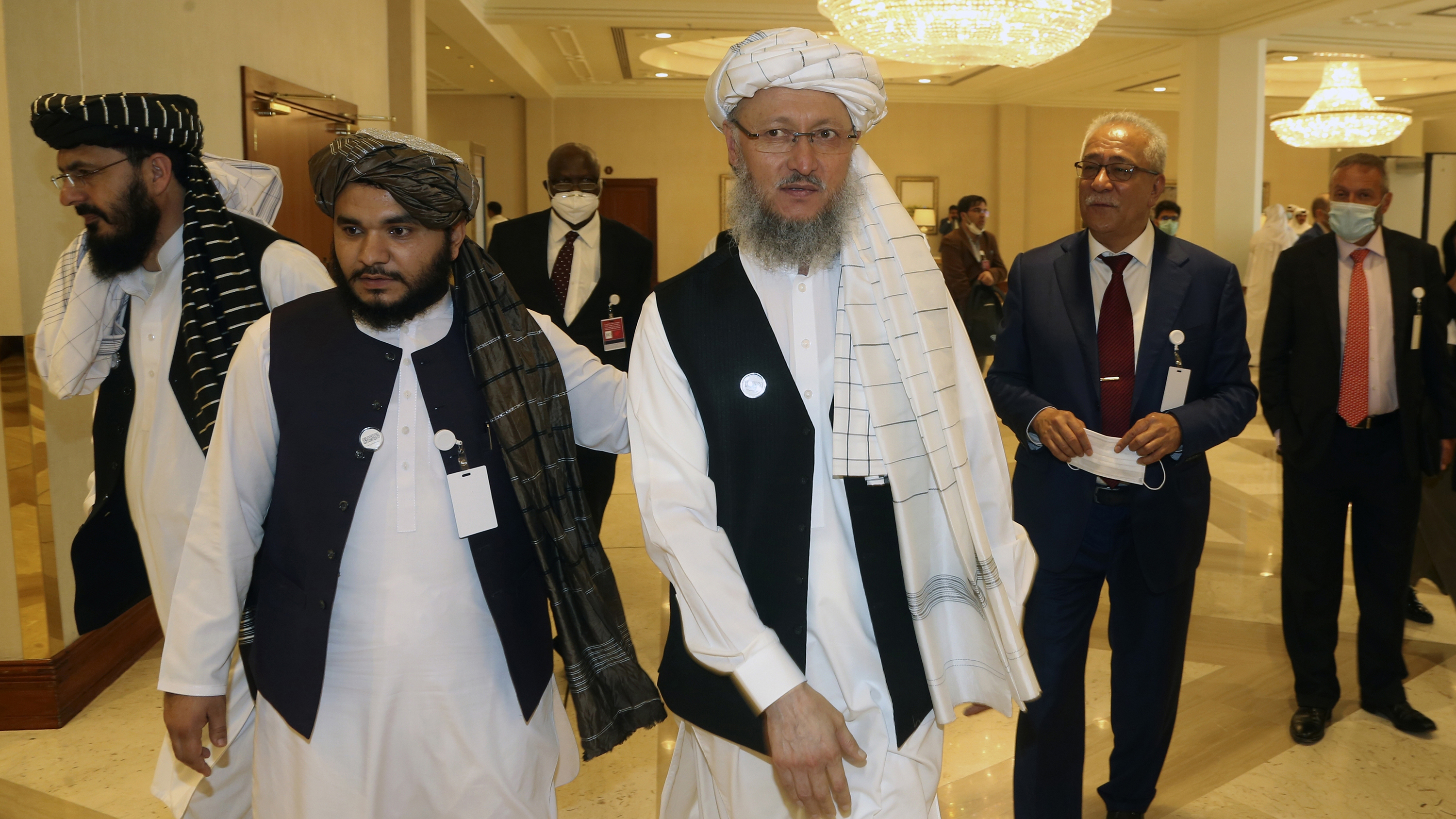 Abdul Salam Hanafi, right, a member of the Taliban negotiating team, heads to the opening session of peace talks between the Afghan government and the Taliban in Doha, Qatar on Saturday.