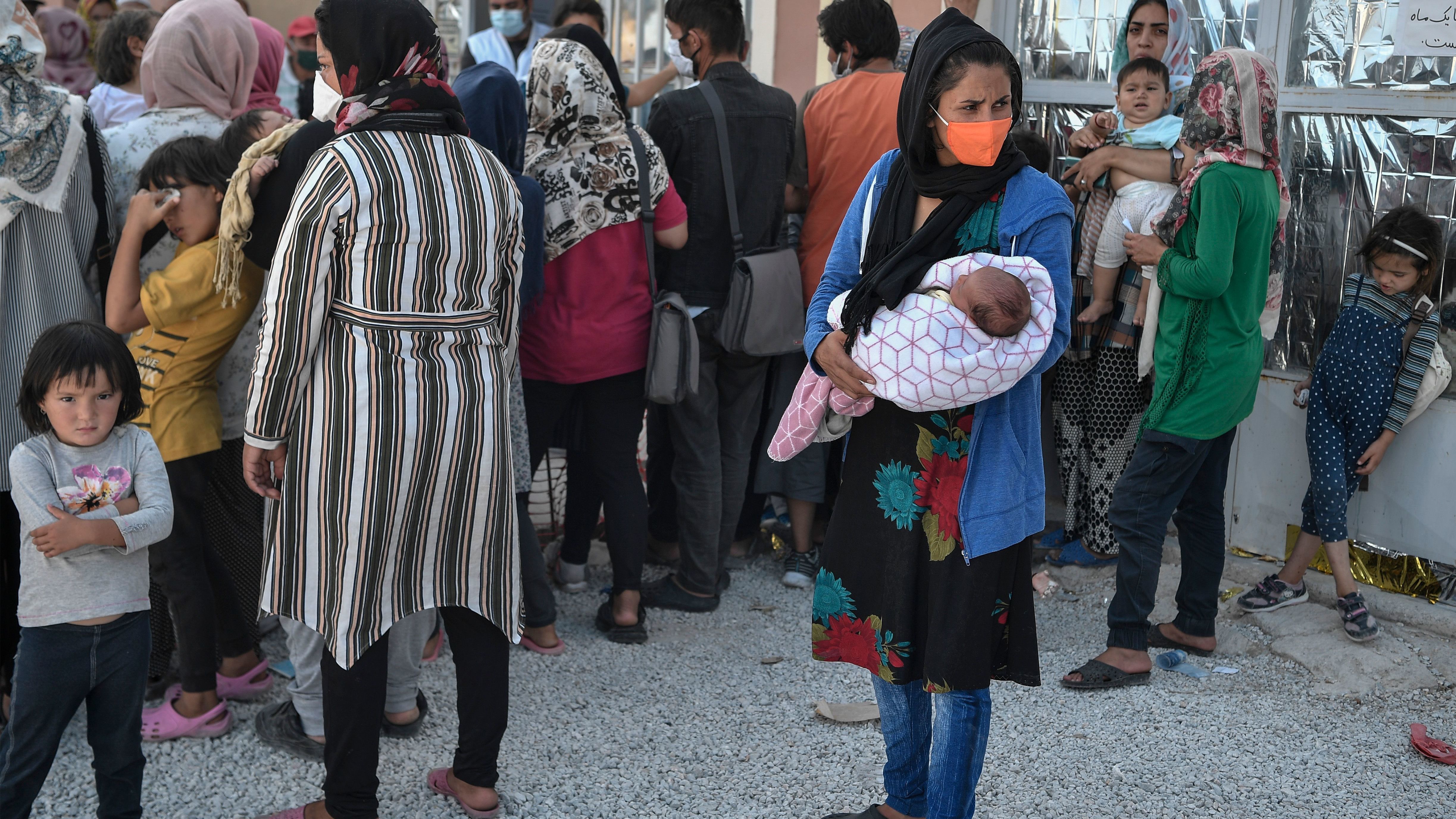 Refugees wait for a medical assistance near Kara Tepe camp on the island of Lesbos on Saturday. Thousands of asylum-seekers on the Greek island of Lesbos languished on roadsides, homeless and hungry after the country