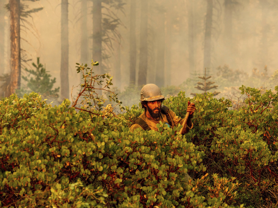 Firefighter Cody Carter battles the North Complex Fire on Monday in Plumas National Forest in California. (Noah Berger/AP)