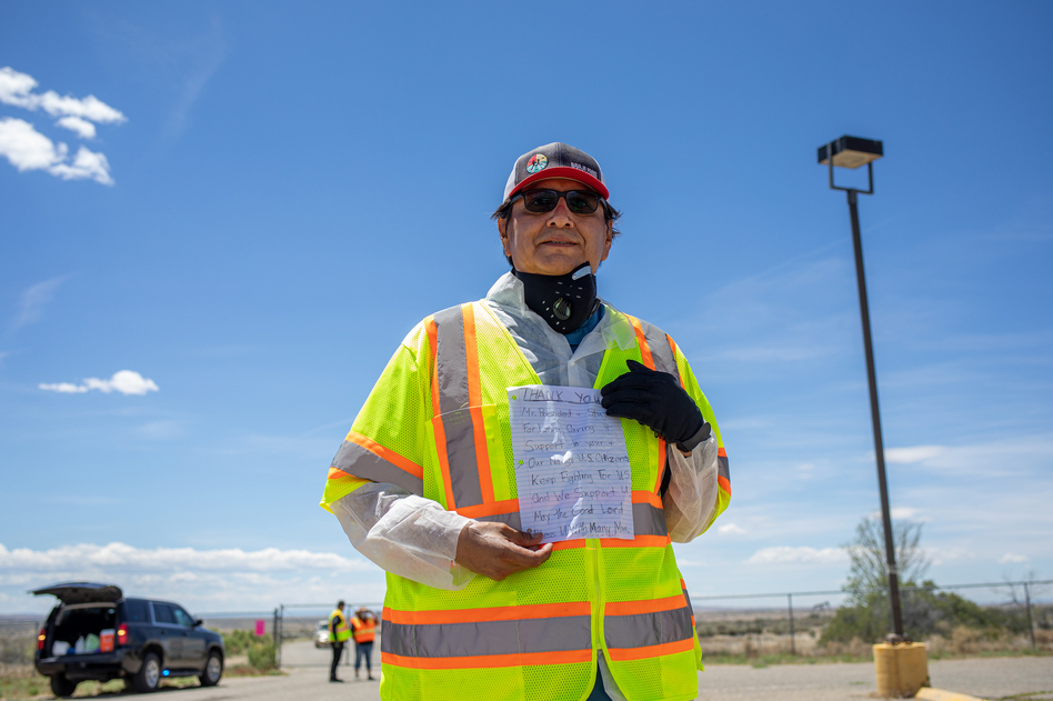 Navajo Nation President Jonathan Nez holds a letter from a Navajo family while distributing food, water and other supplies on May 27, on the Navajo Nation Reservation in New Mexico. (Sharon Chischilly/Getty Images)