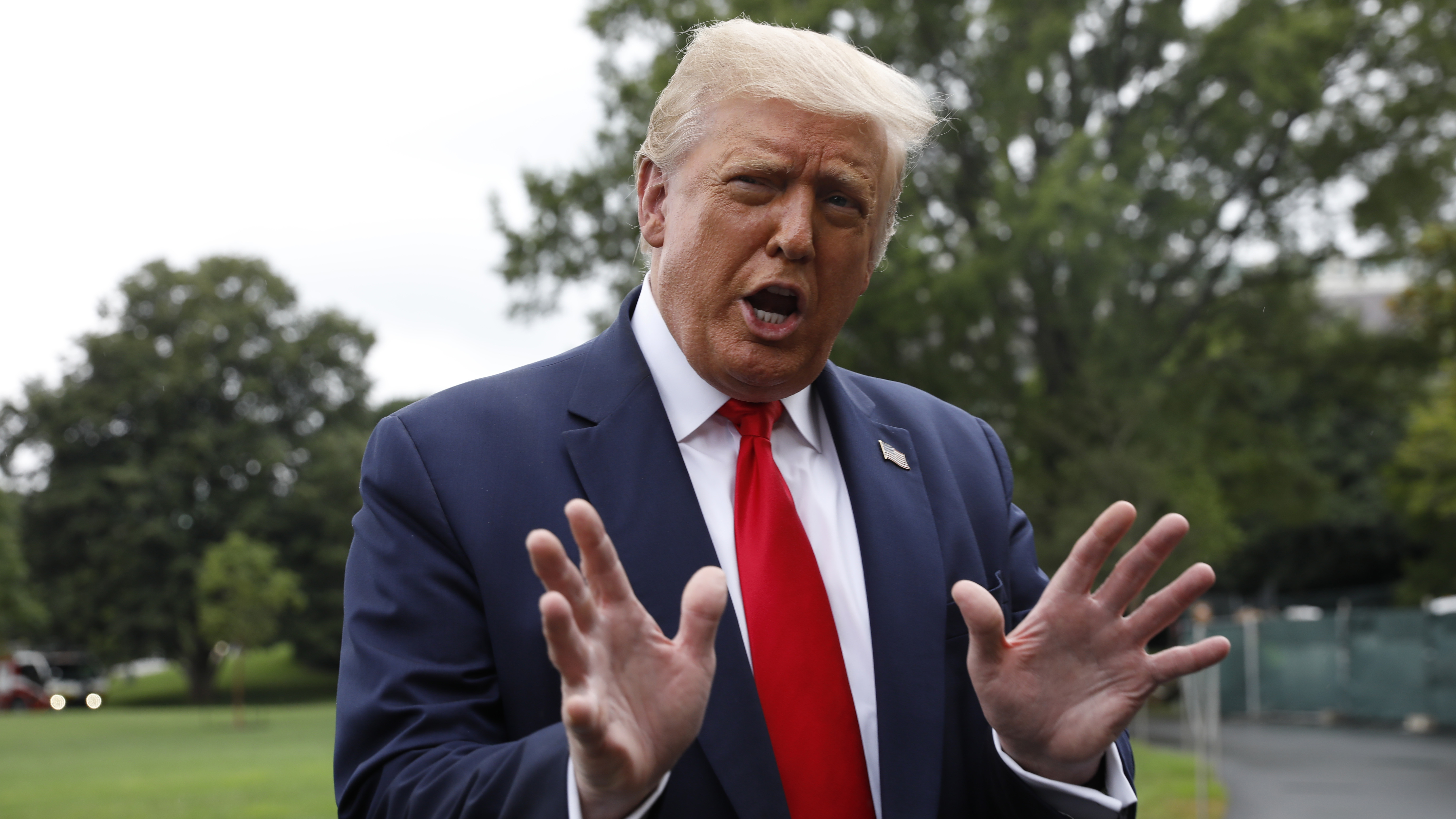 President Trump speaks to members of the media before boarding Marine One on the South Lawn of the White House in July. (Bloomberg via Getty Images)
