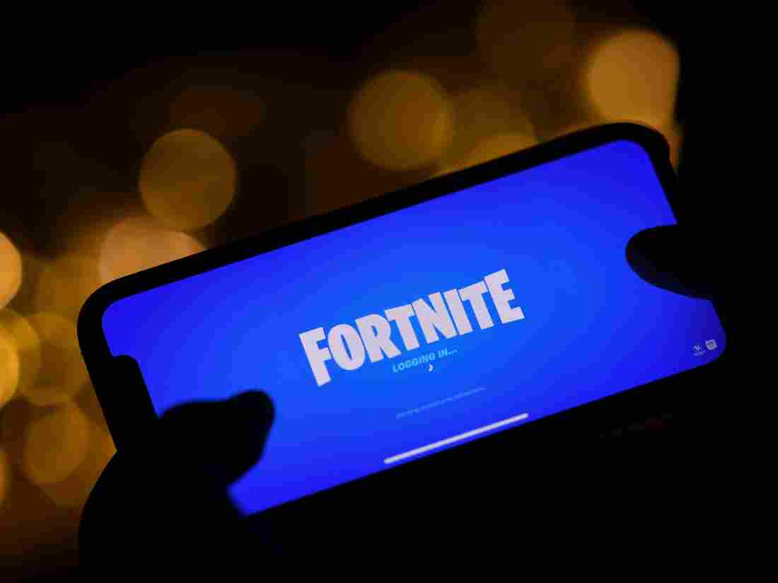Logging into Epic Games' Fortnite on a smartphone. (Photo by Chris DELMAS / AFP) (Photo by CHRIS DELMAS/AFP via Getty Images)