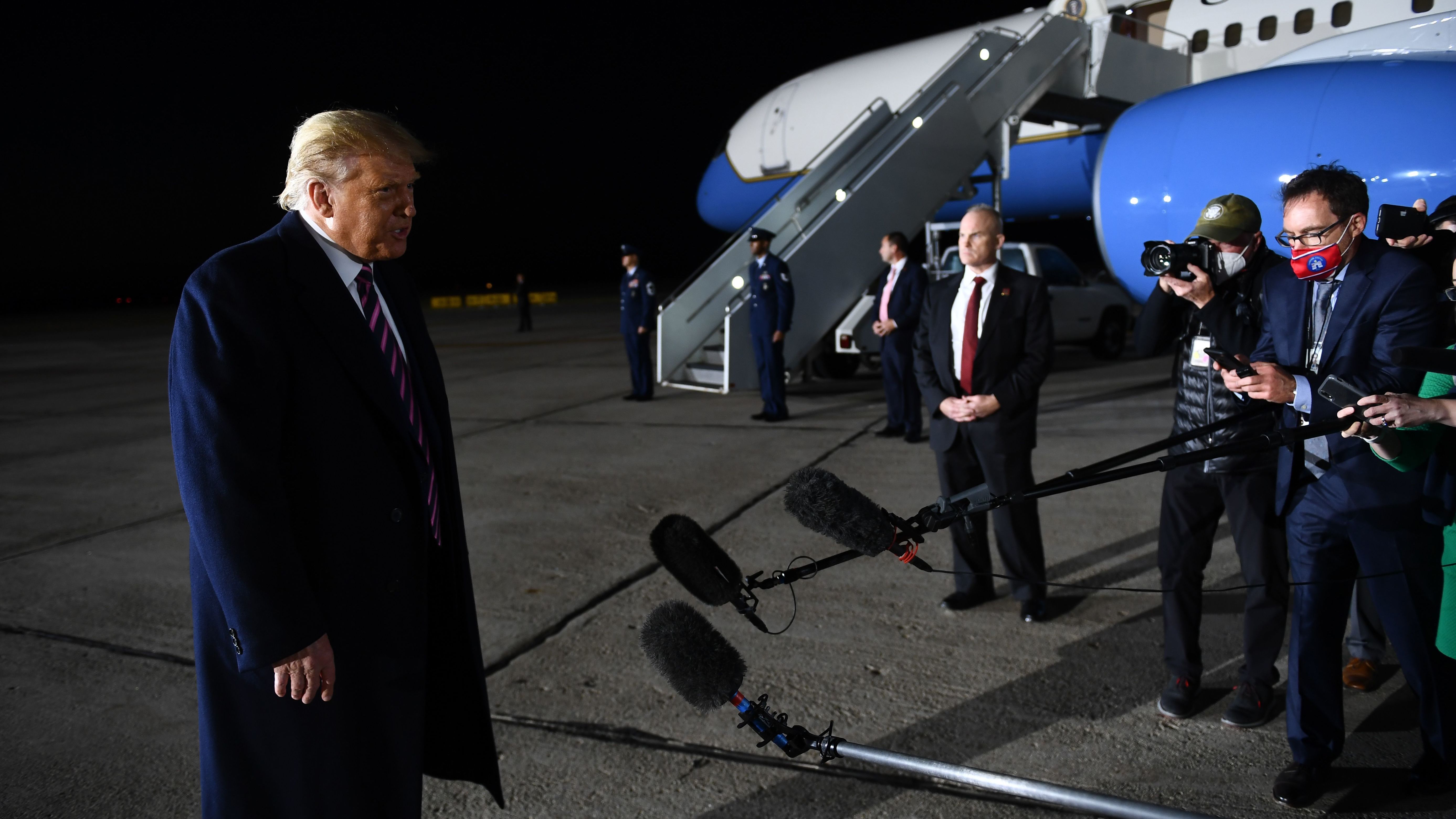 President Trump reacts to the news of Justice Ruth Bader Ginsburg's death on Friday at Bemidji Regional Airport in Minnesota. He told reporters on the tarmac after his rally that he learned the news from them. (AFP via Getty Images)