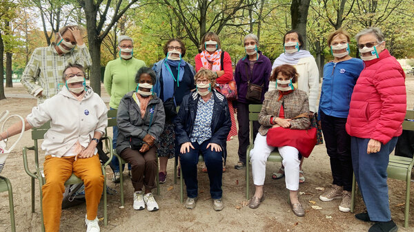 Suzy Margueron (seated, center) who advocates for people with hearing loss, likes to gather with friends in Paris