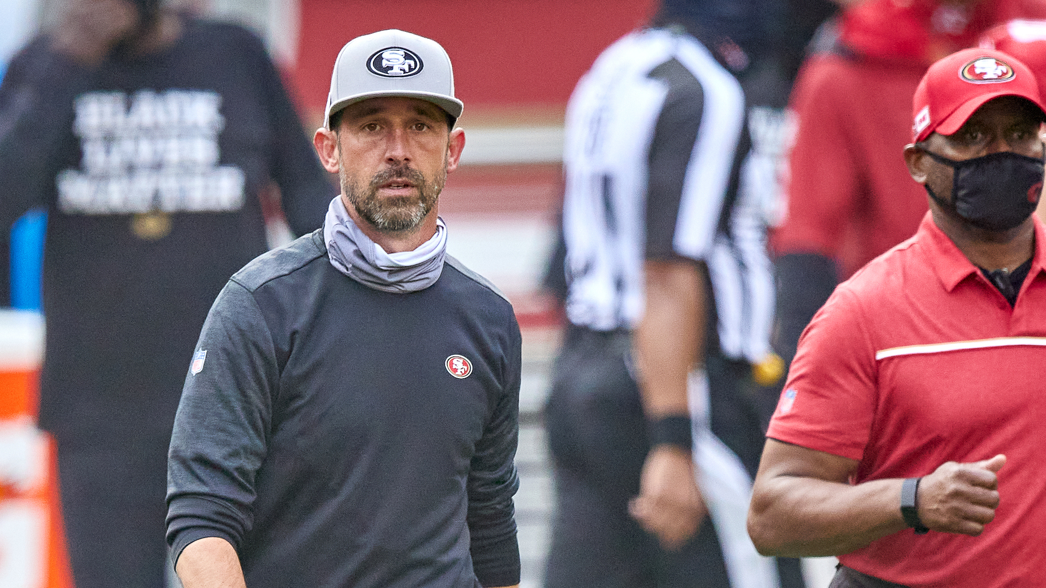 The NFL has fined San Francisco 49ers head coach Kyle Shanahan and two other coaches for not following rules about keeping their faces covered. Here, Shanahan walks off the field after his team's Sept. 13 game against the Arizona Cardinals. (Icon Sportswire via Getty Images)