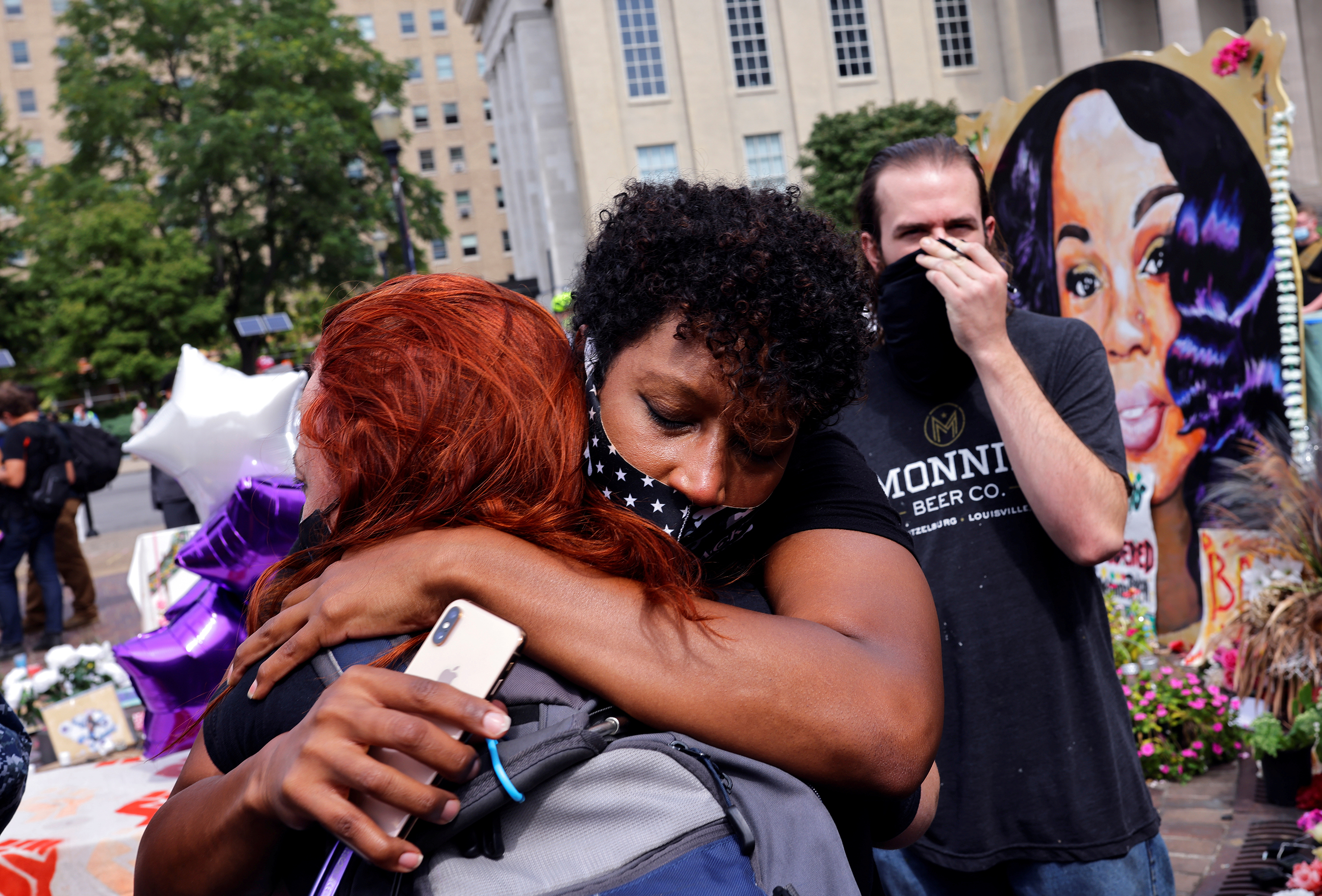 People react Wednesday after the grand jury's decision in the March shooting death of Breonna Taylor by police in her home in Louisville, Ky. (Reuters)