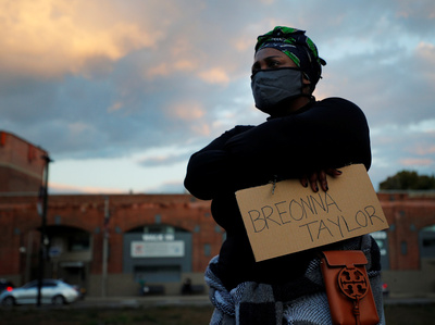 A demonstrator listens to a speech at a vigil in Boston.