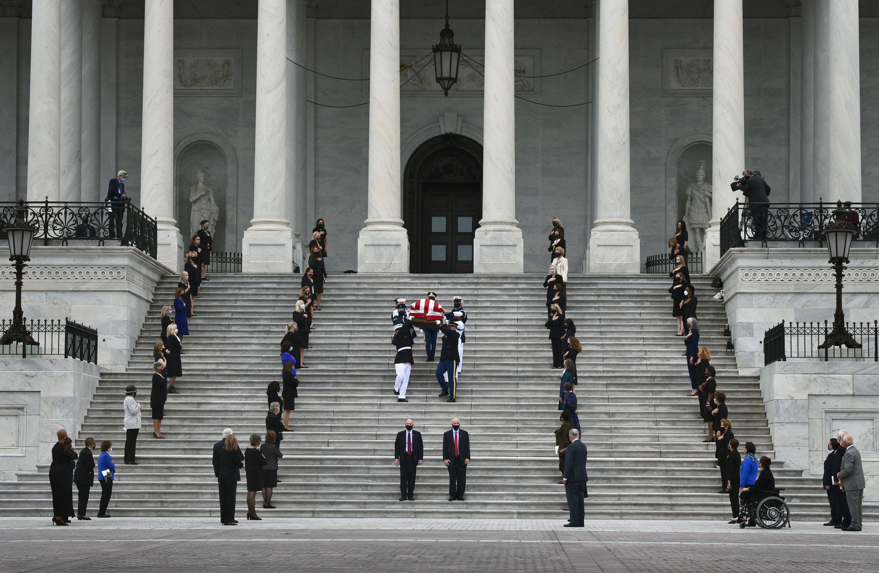 Justice Ruth Bader Ginsburg's casket leaves the U.S. Capitol. (Carol Guzy for NPR)