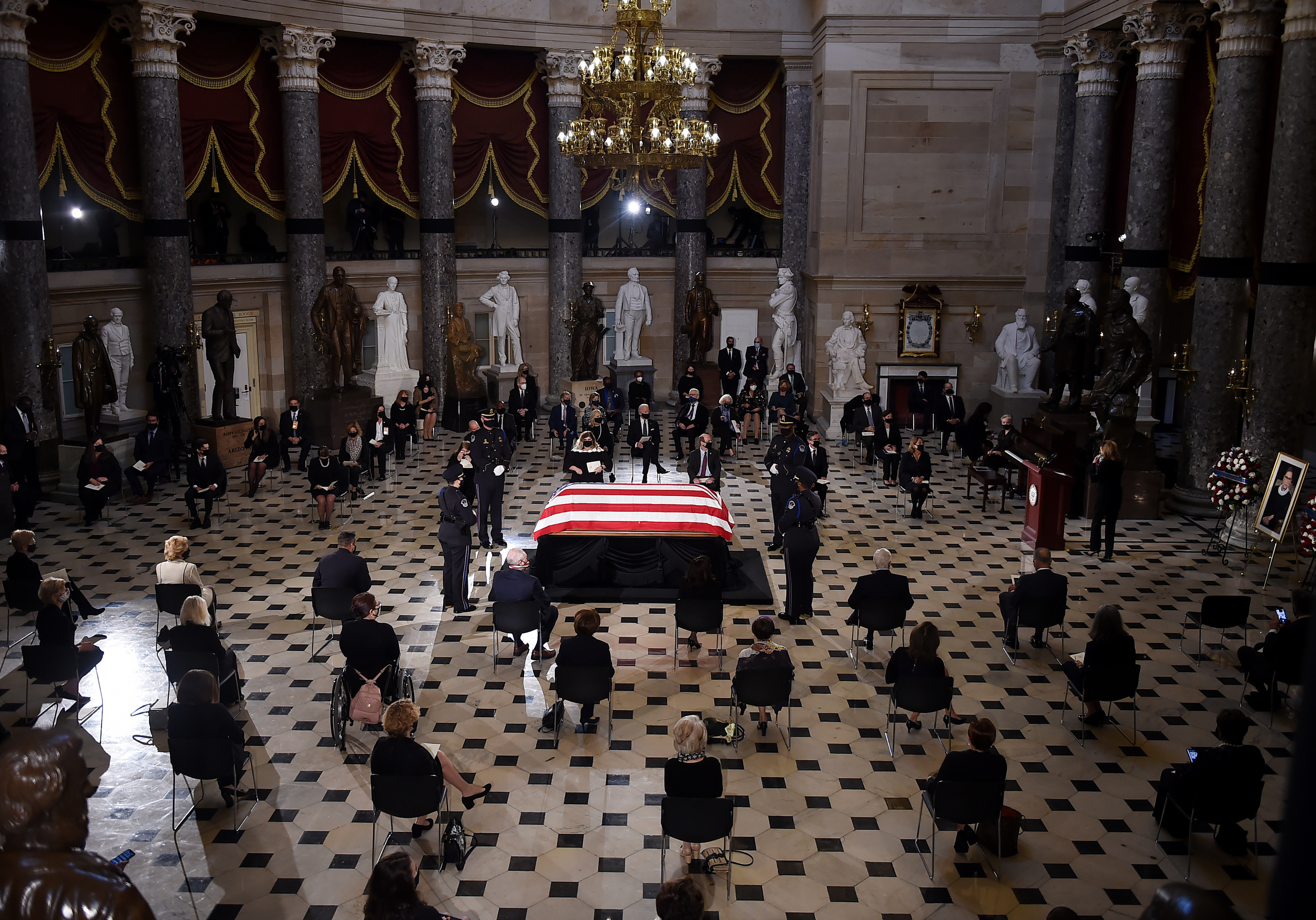 Members of Congress and guests pay their respects to the late Associate Justice Ruth Bader Ginsburg as her casket lies in state during a memorial service in her honor in Statuary Hall of the U.S. Capitol. (Pool/AFP via Getty Images)