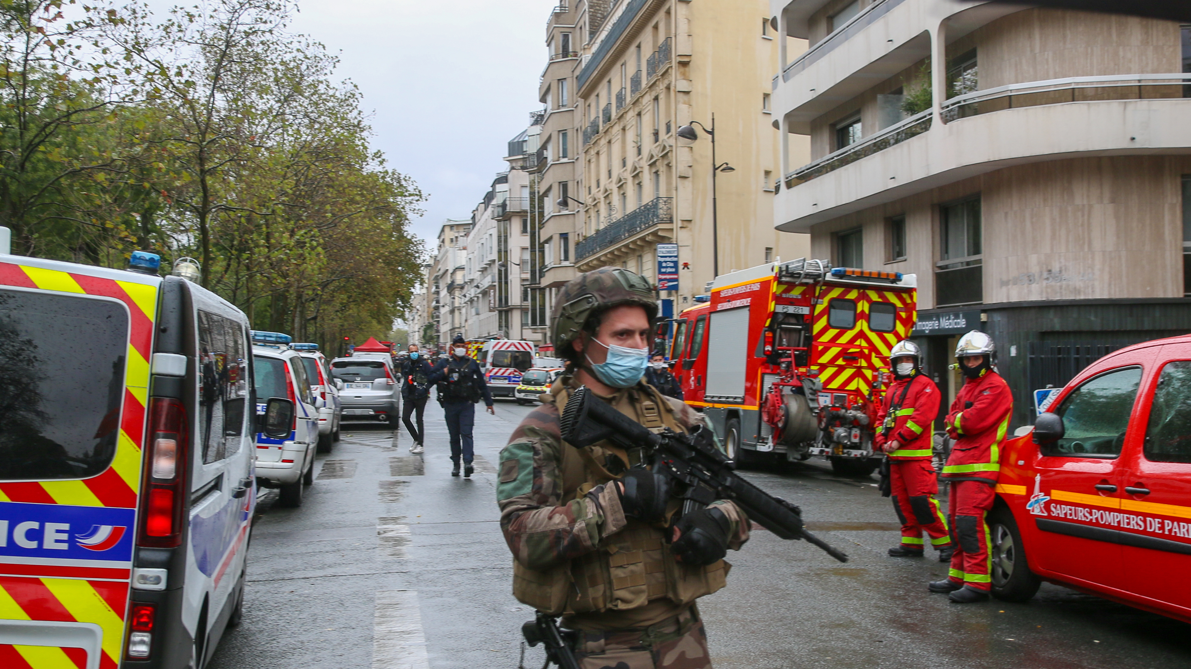 An officer of the French National Gendarmerie guards an area near the former Paris offices of satirical newspaper Charlie Hebdo, where two people were wounded Friday in an attack with a sharp object that one witness described as a hatchet.