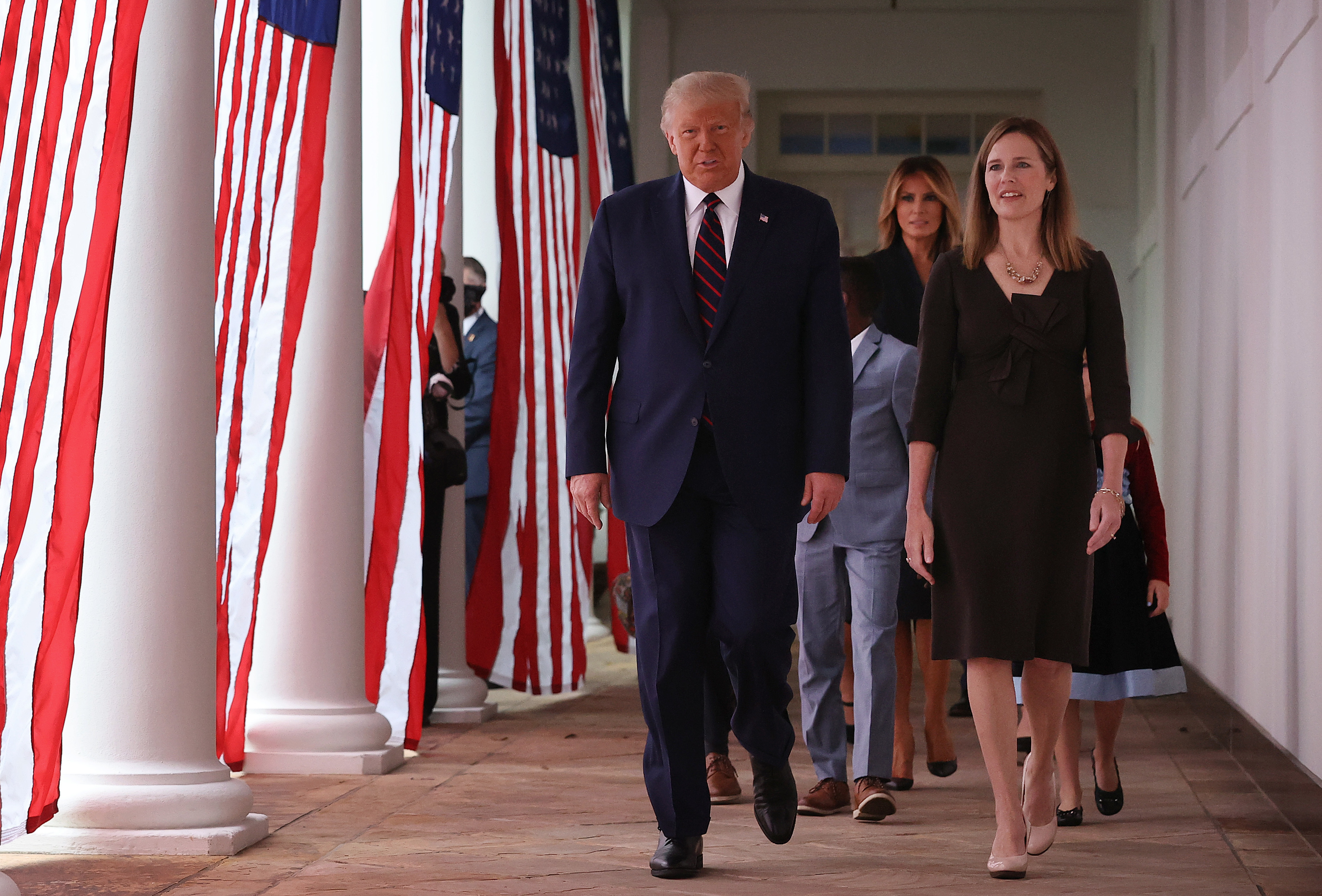 President Trump and Supreme Court nominee Amy Coney Barrett walk along the Rose Garden colonnade on Saturday. The focus on the court just weeks before the election could help energize conservatives in key states. (Getty Images)
