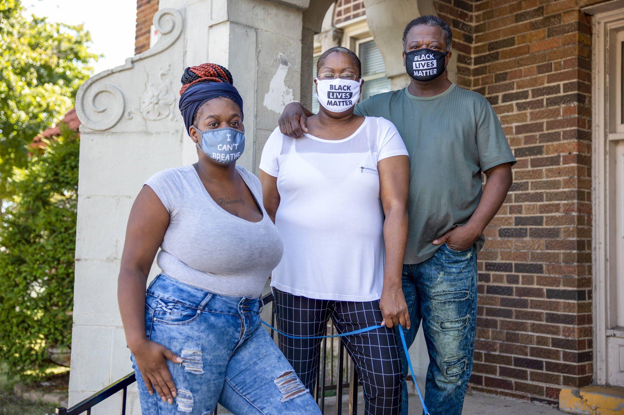 Heavenly Pettigrew, left, and her parents Stephanie and Robert outside their two-bedroom rental apartment in Milwaukee. Without assistance from the nonprofit Community Advocates, the family likely would have faced eviction after the pandemic forced Robert and Heavenly out of their steady jobs. (Wisconsin Watch)