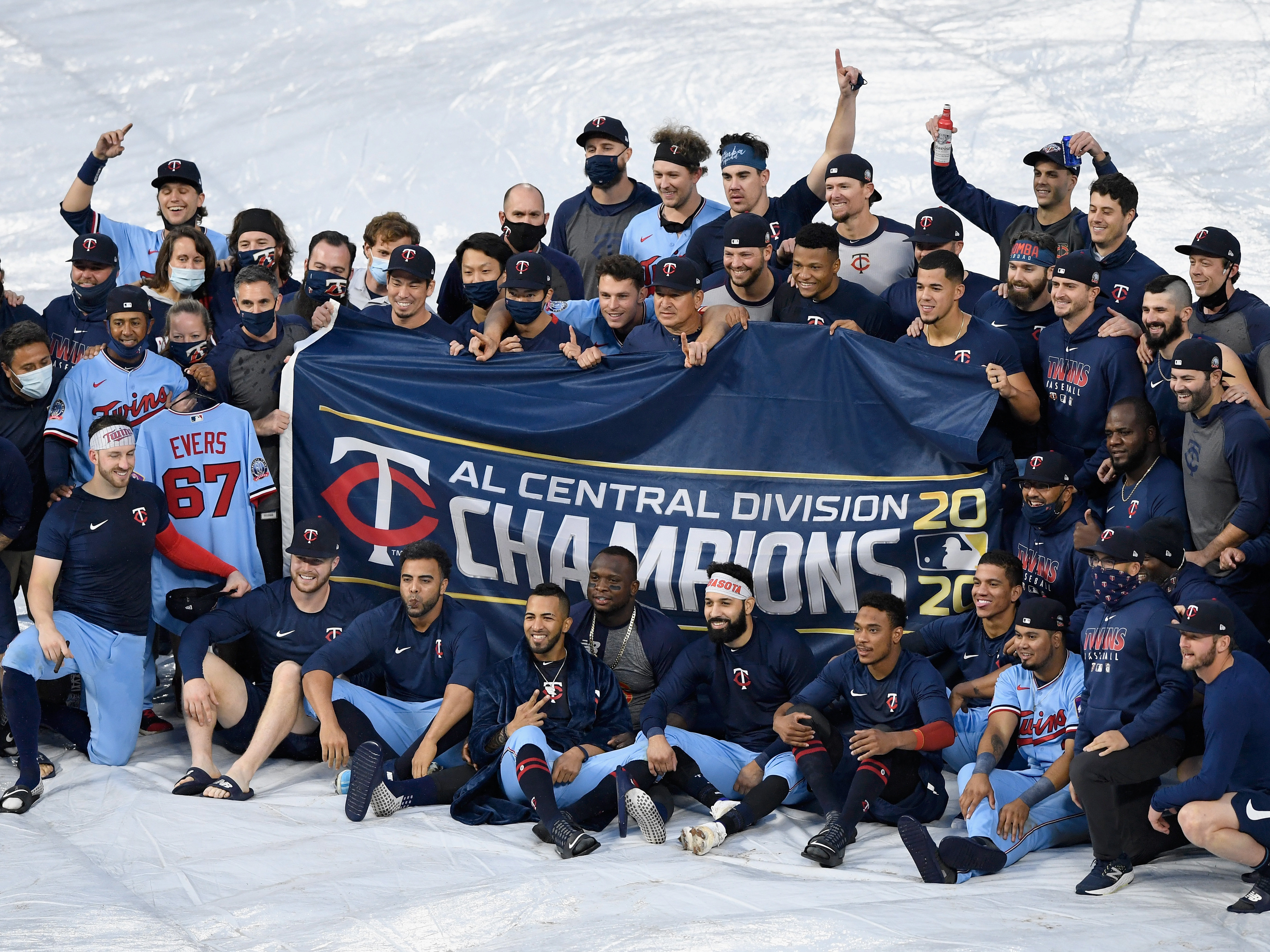 The Minnesota Twins celebrate being the American League Central Division champions after the game against the Cincinnati Reds on Sunday in Minneapolis. (Getty Images)