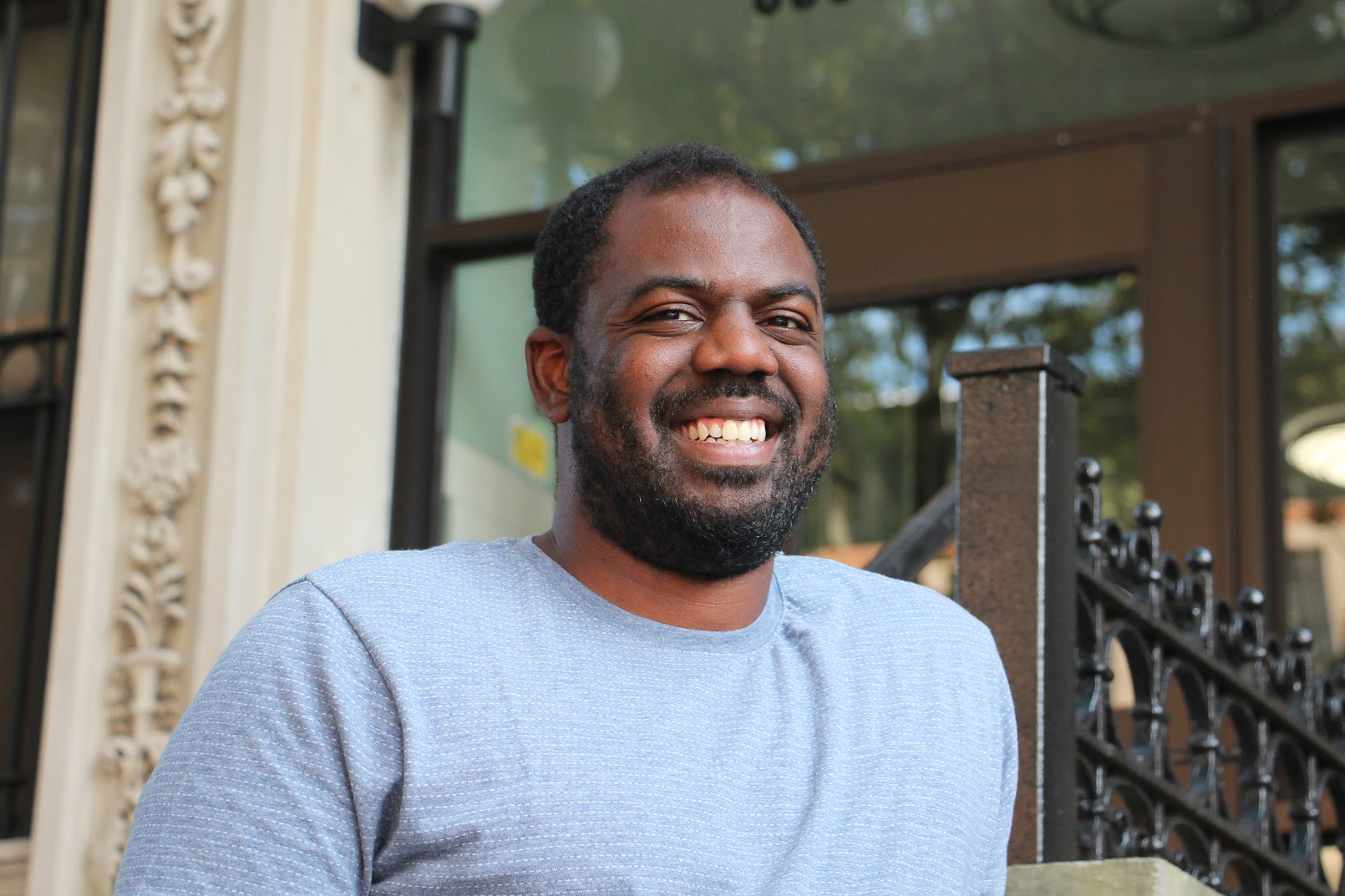Donnel Baird stands in front of a building where his company, BlocPower, has installed energy-saving heating and solar panels. &quot;Solar panels aren't just for rich people, or for White people. They're for everybody,&quot; Baird says. (NPR)