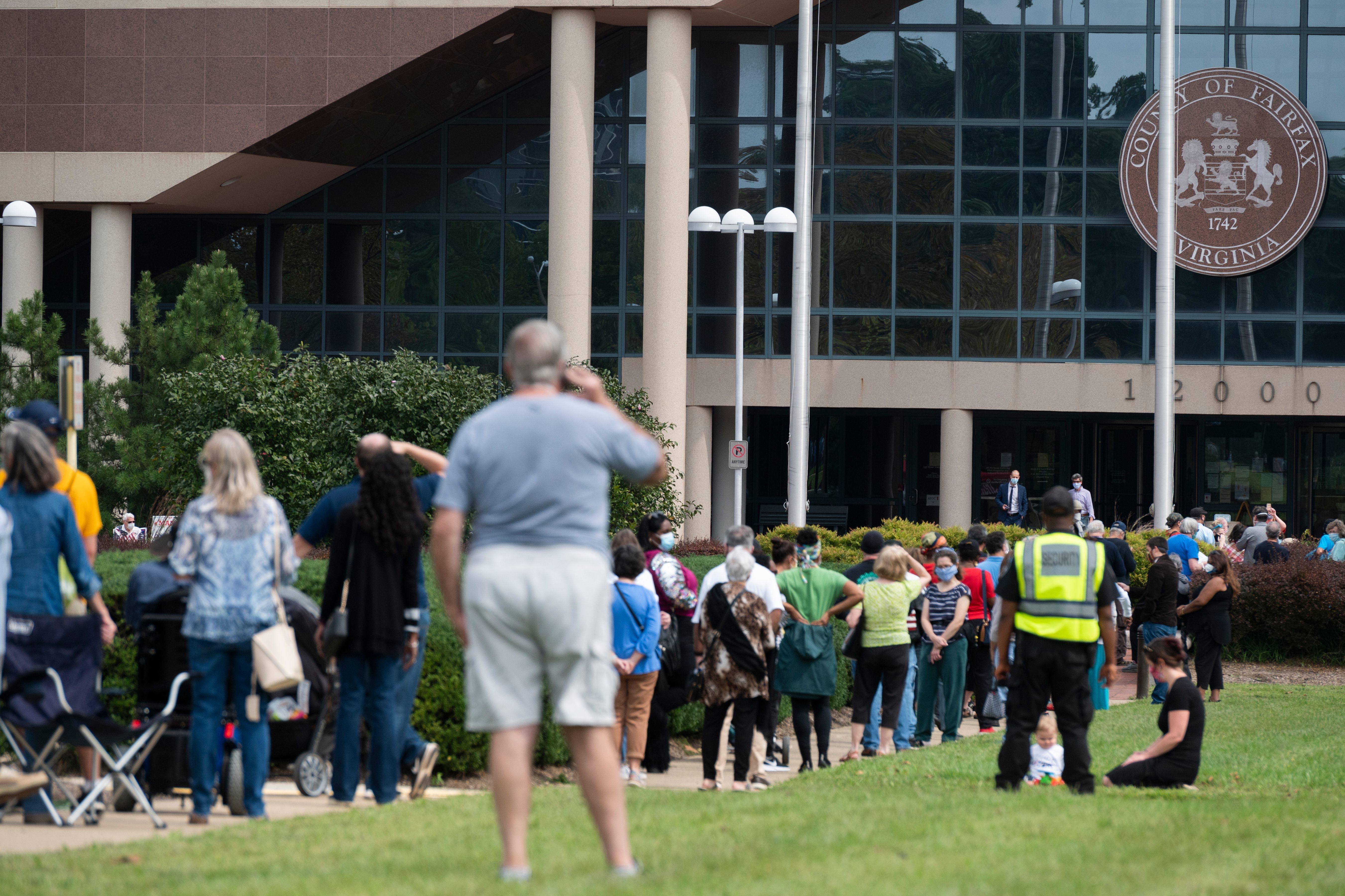 Voters wait in line to cast their ballot at an early voting location in Fairfax, Va., on Sept. 18. Growing tensions in the country have some election officials worried about potential violence at polling places. (AFP via Getty Images)