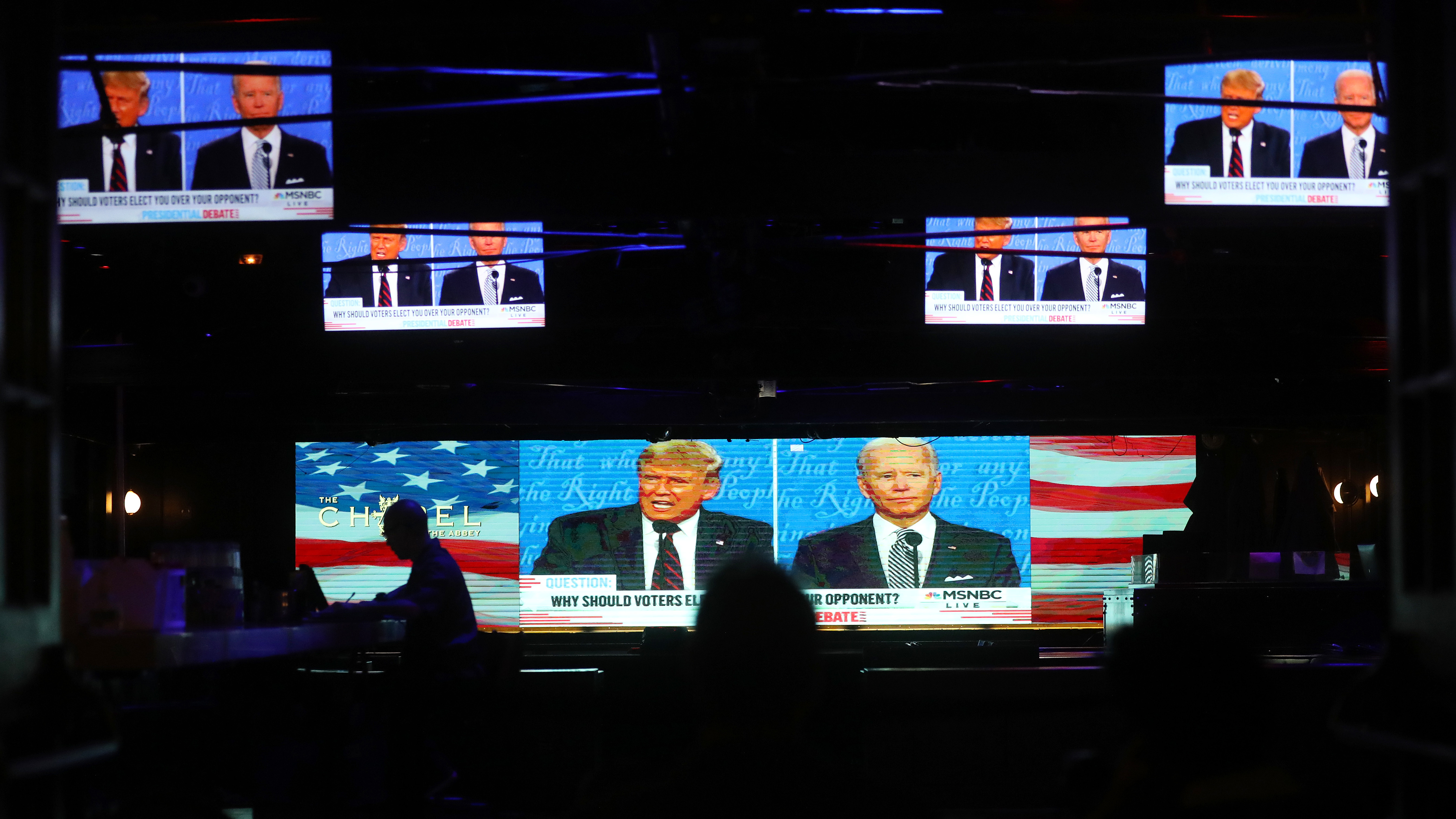 A broadcast of the first debate between President Trump and Democratic nominee Joe Biden is played on TVs at The Abbey in West Hollywood, Calif. (Getty Images)