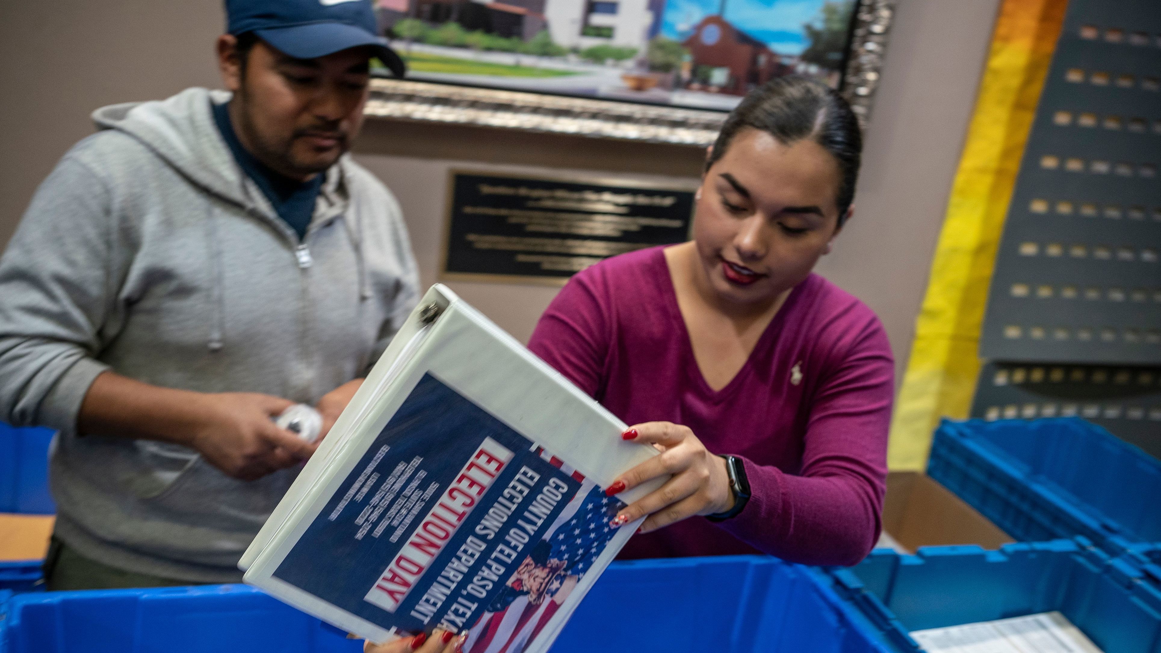 Jonathan Lucero and Valeria Gutierrez prepare to receive ballots at the El Paso County Courthouse during the presidential primary in March.