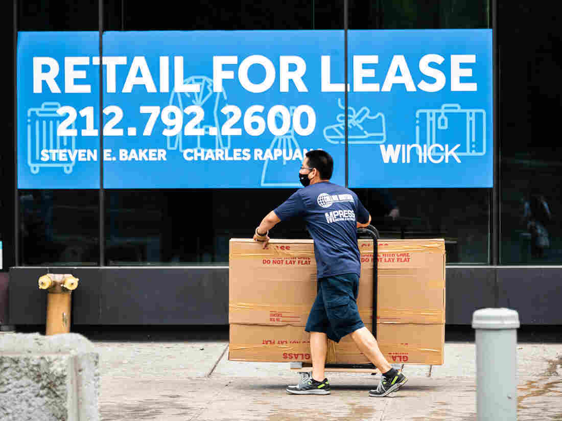 NEW YORK, NEW YORK - SEPTEMBER 29: A mover walks past a vacant store in Union Square as the city continues Phase 4 of re-opening following restrictions.