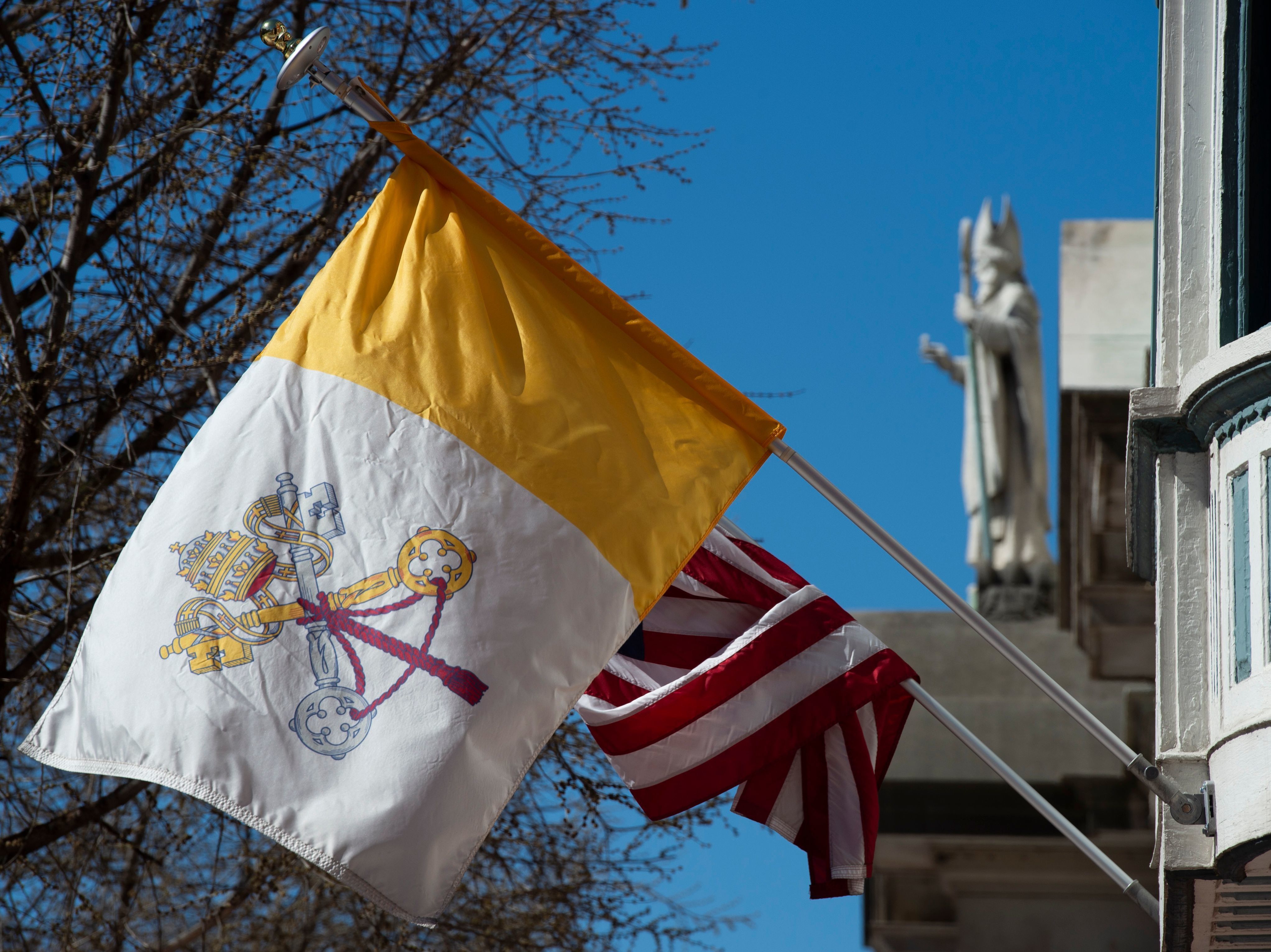 The U.S. flag and flag of Vatican City are hung on the outside of the Pennsylvania Catholic Conference building in Harrisburg, Pa., on March 26, 2019. Catholics outnumber Evangelicals in Pennsylvania by a 2-to-1 margin. (AFP via Getty Images)