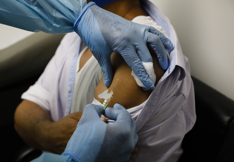 A volunteer in a clinical trial for an experimental COVID-19 vaccine receives an injection last month at Research Centers of America in Hollywood, Fla. (Eva Marie Uzcategui/Bloomberg via Getty Images)
