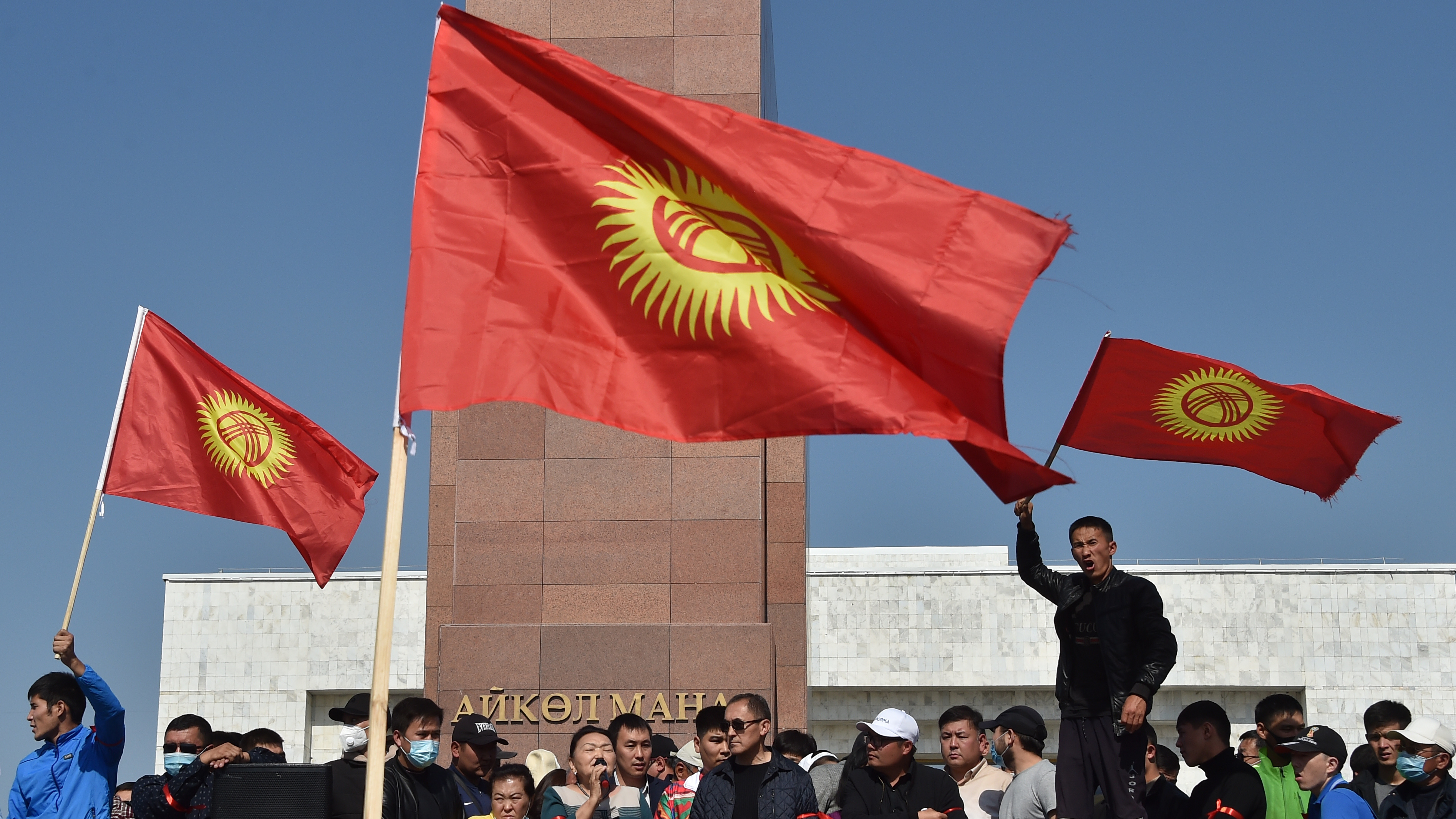 People protest beside the parliament building in Bishkek, which also houses the offices of Kyrgyzstan