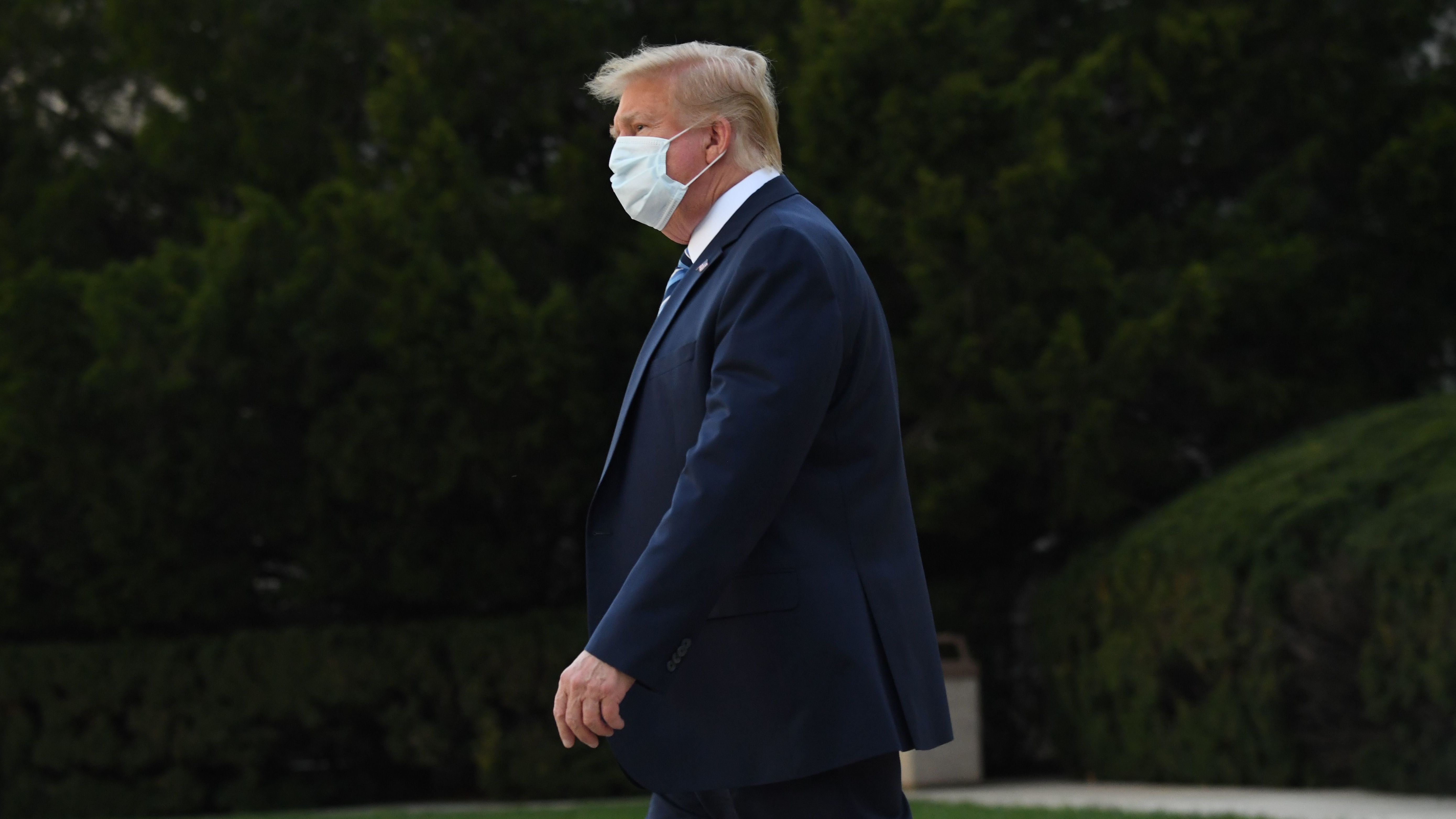 President Trump leaves Walter Reed National Military Medical Center in Bethesda, Md., on Monday. He announced Tuesday he was pausing negotiations on a coronavirus relief package. (AFP via Getty Images)