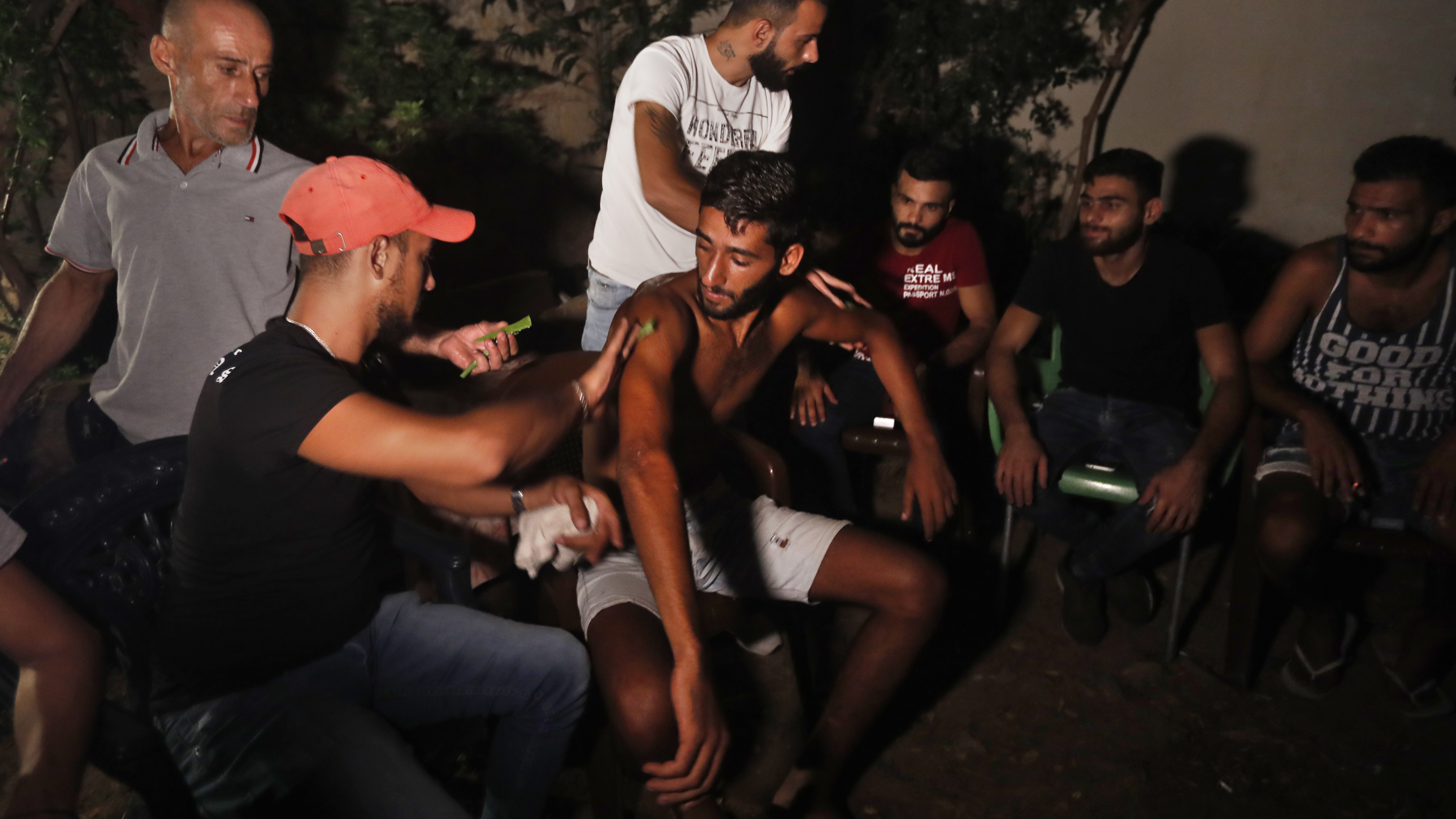 Ibrahim Lasheen, 22, is brought back to his hometown of Tripoli, Lebanon, in September. A U.N. naval force rescued him after he swam for 18 hours to seek help for dozens of fellow passengers crammed on a small fishing boat that ran out of fuel as it headed to Cyprus.