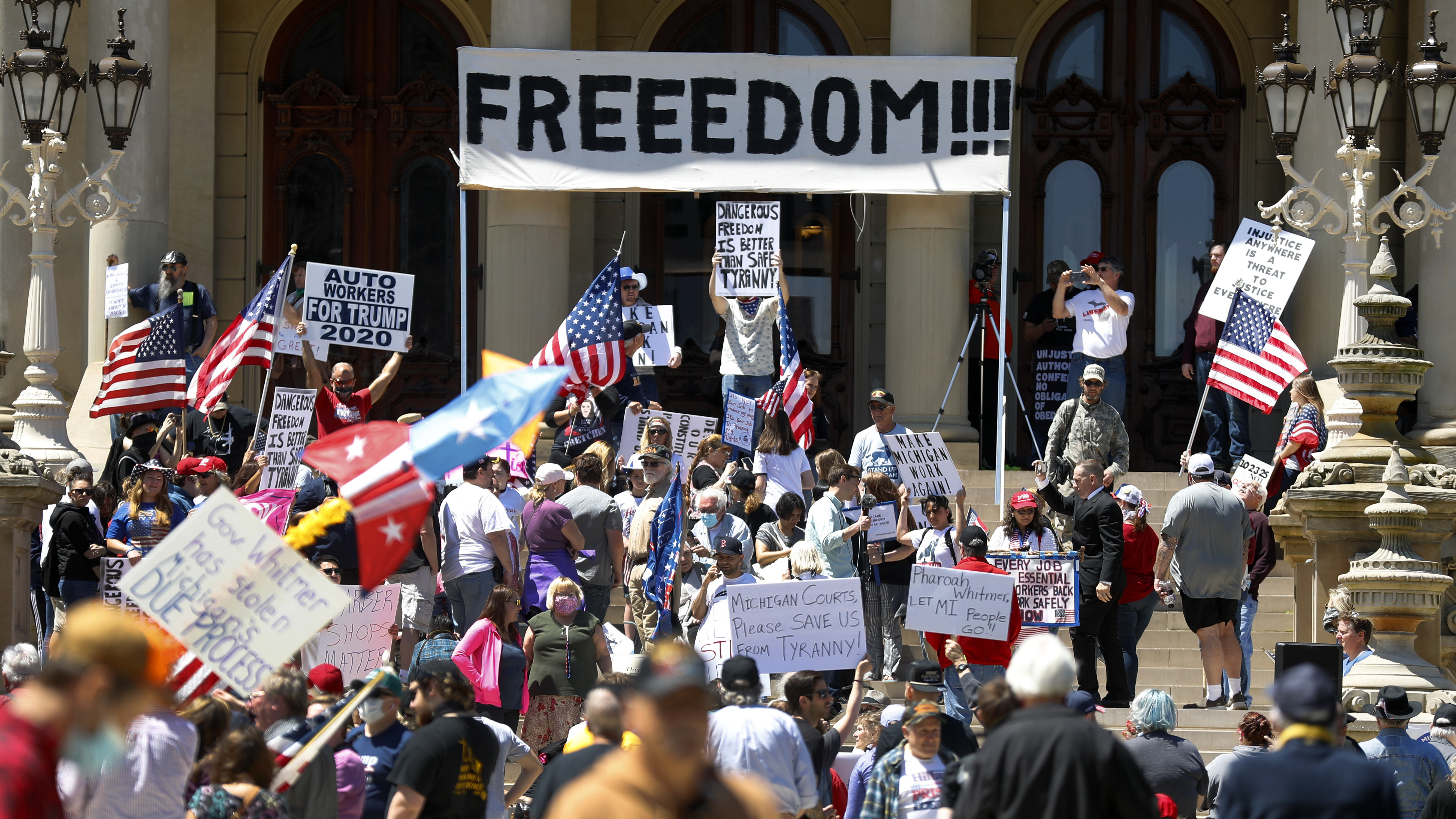 People protest at the state Capitol during a rally in Lansing, Mich., in May against Gov. Gretchen Whitmer