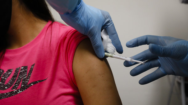 A volunteer received an injection as part of a clinical trial for a COVID-19 vaccine at Research Centers of America in Hollywood, Fla. Studies of vaccines backed by Operation Warp Speed have enrolled tens of thousands of people in a matter of months.