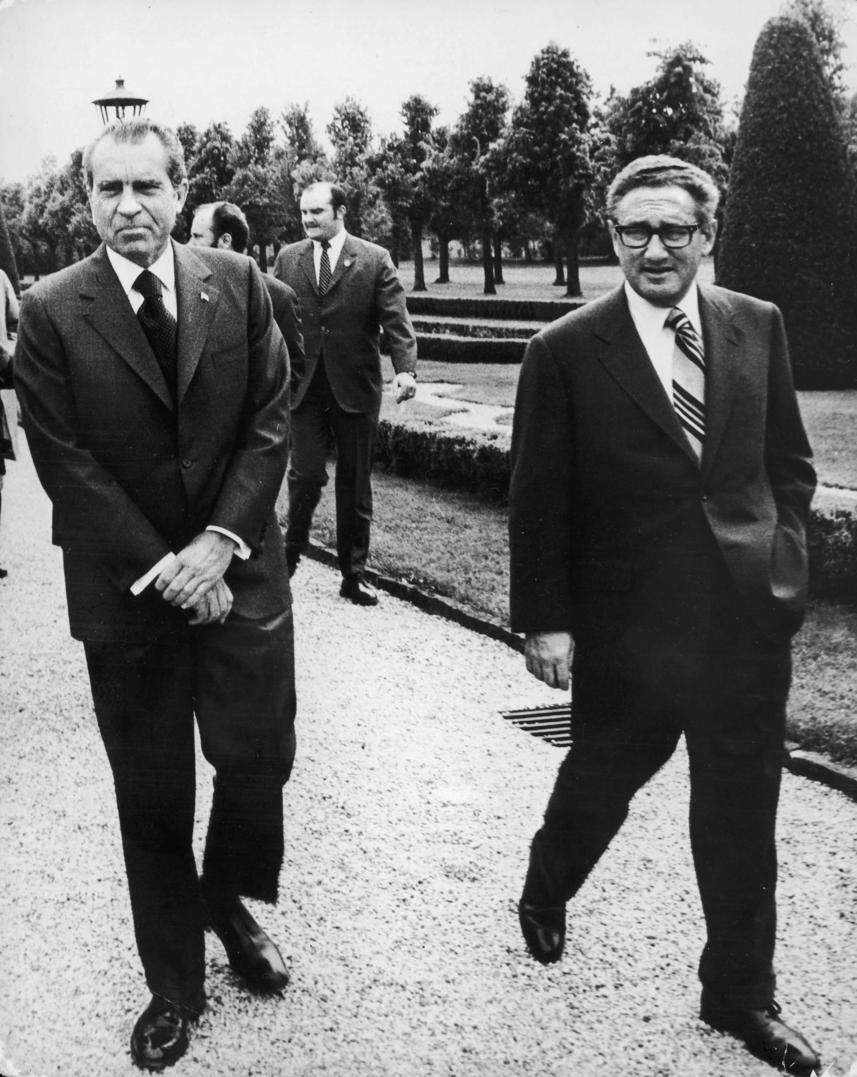 President Nixon walks with U.S. Secretary of State Henry Kissinger in 1972, during peace talks in Paris that were aimed at ending the Vietnam War. A year later, Kissinger was awarded the Nobel Peace Prize for his role in negotiating the ceasefire.