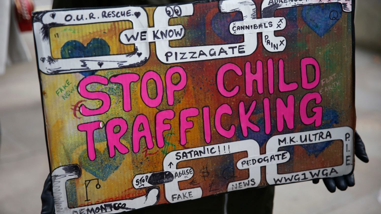 A protestor holds a sign during a &quot;Save our Children&quot; rally outside Downing Street in London, England. Conspiracy theorists have recently coopted #SaveTheChildren to find new followers. (Hollie Adams/Getty Images)