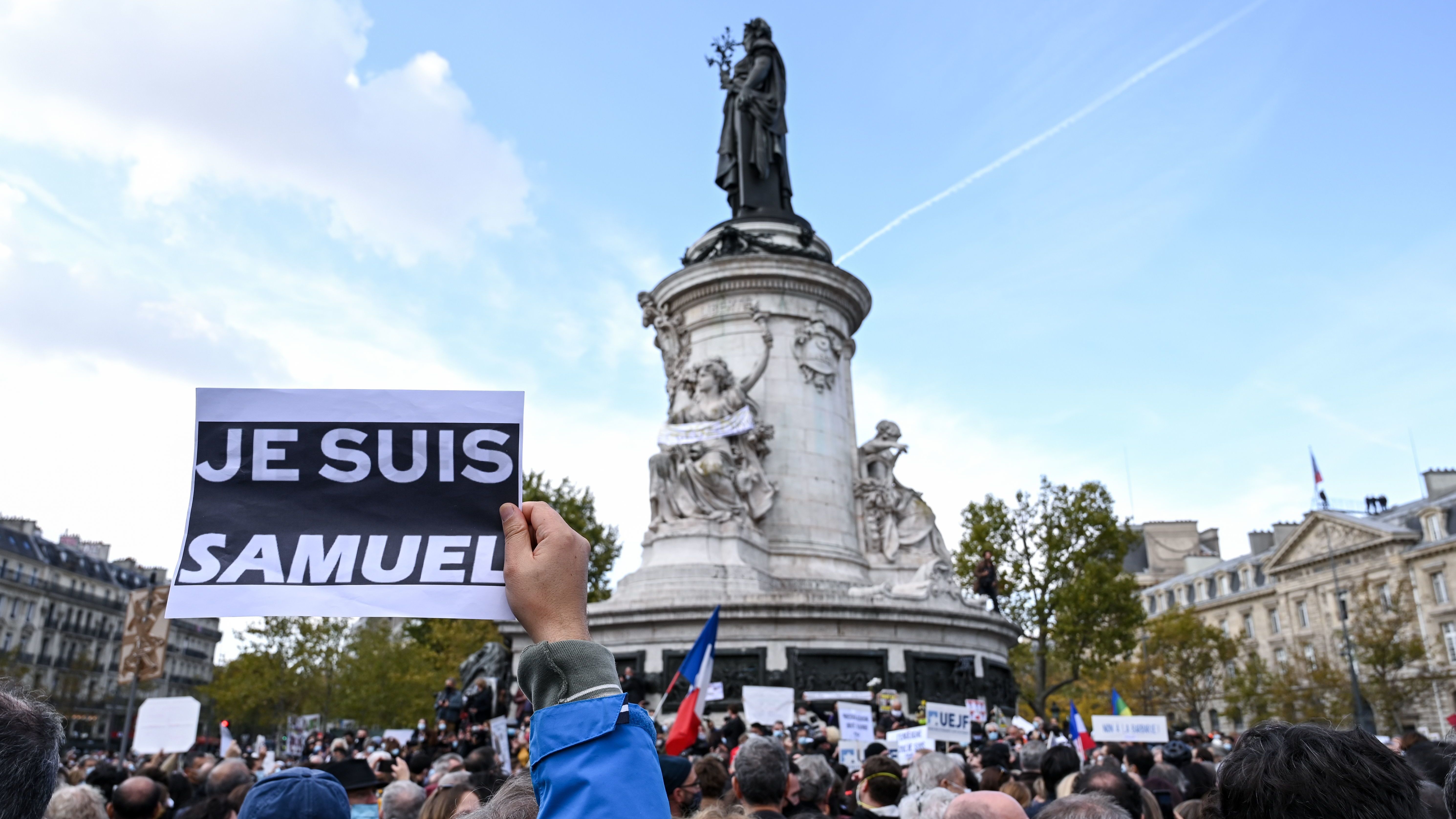 Demonstrators like the one shown here carried "I am Samuel" signs as they gathered on Place de la République in Paris on Sunday to pay tribute to slain history teacher Samuel Paty. Similar gatherings took place in several other cities as France reels from the attack.