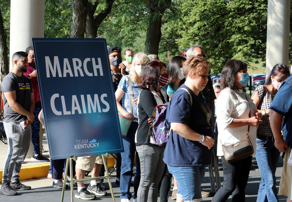 Hundreds of unemployed Kentucky residents wait in long lines outside the Kentucky Career Center in Frankfort for help with their unemployment claims on June 19. New research shows savings built up by the jobless are starting to run out. (John Sommers II/Getty Images)