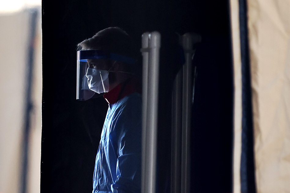 A health care worker prepares to screen people for the coronavirus at a testing site in Landover, Md., in March. (Chip Somodevilla/Getty Images)