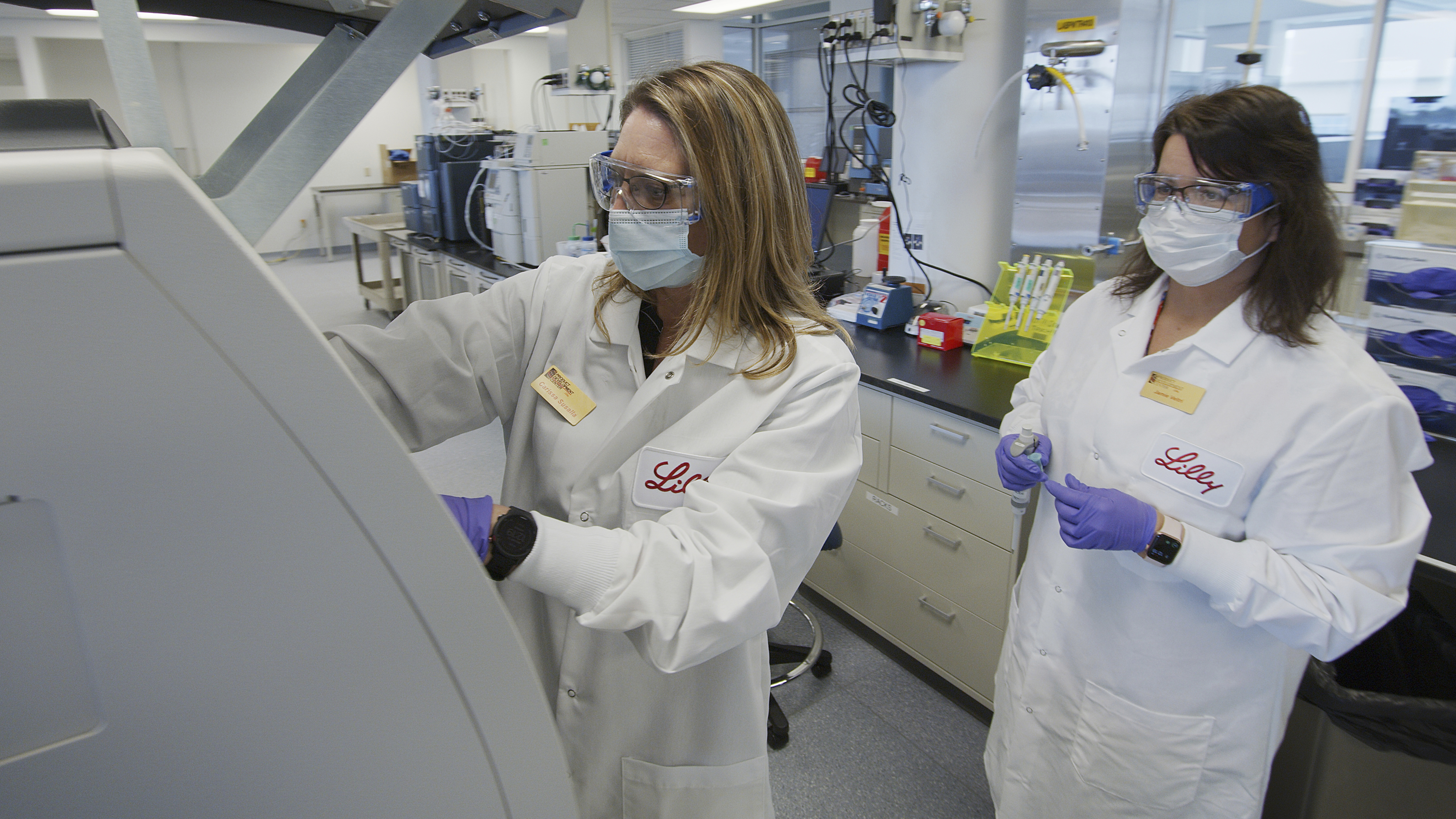 Eli Lilly researchers prepare cells to produce possible COVID-19 antibodies in a laboratory in Indianapolis. The drugmaker has asked the U.S. government to allow emergency use of its experimental antibody therapy.