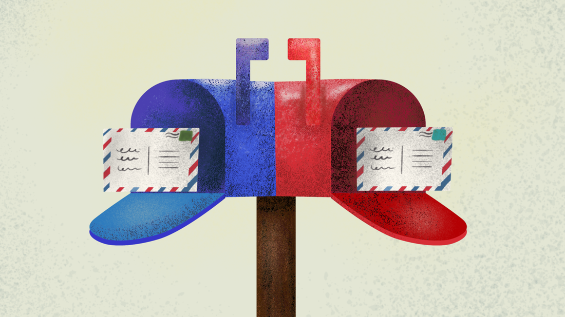 A blue and red mailbox with postcards inside