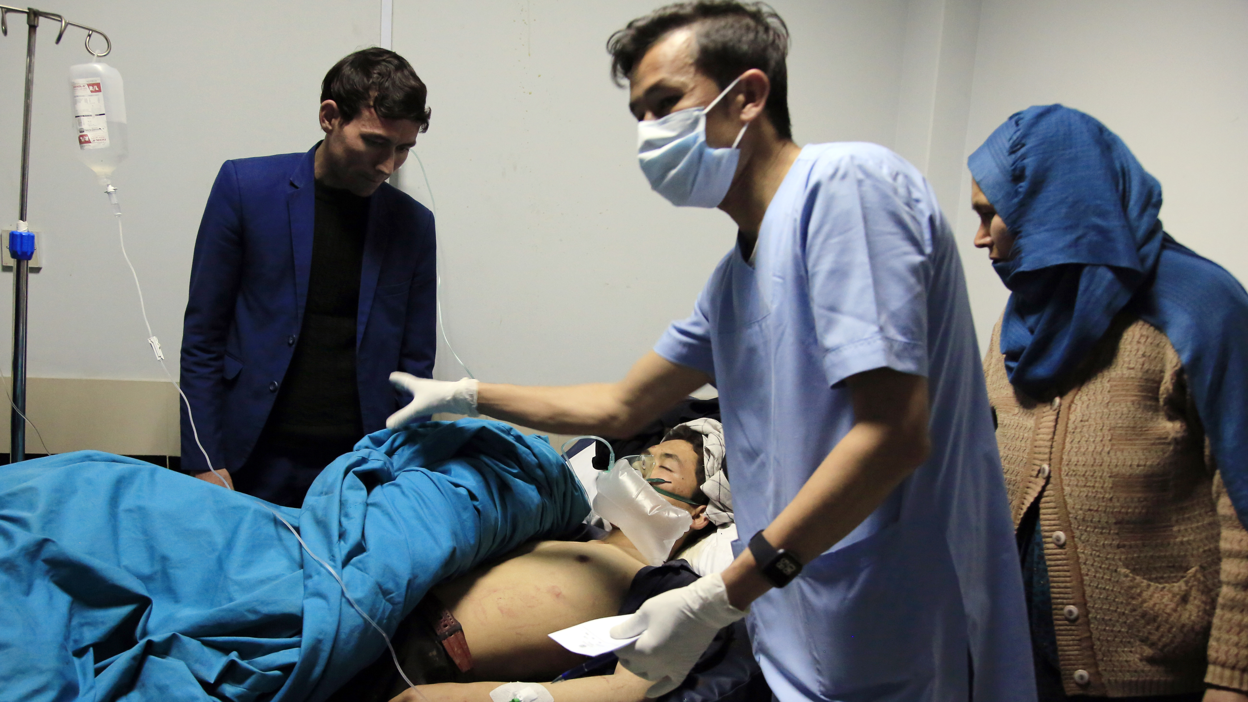 Patients are treated at a hospital after a suicide attack in Kabul, Afghanistan, on Saturday. Dozens were injured.