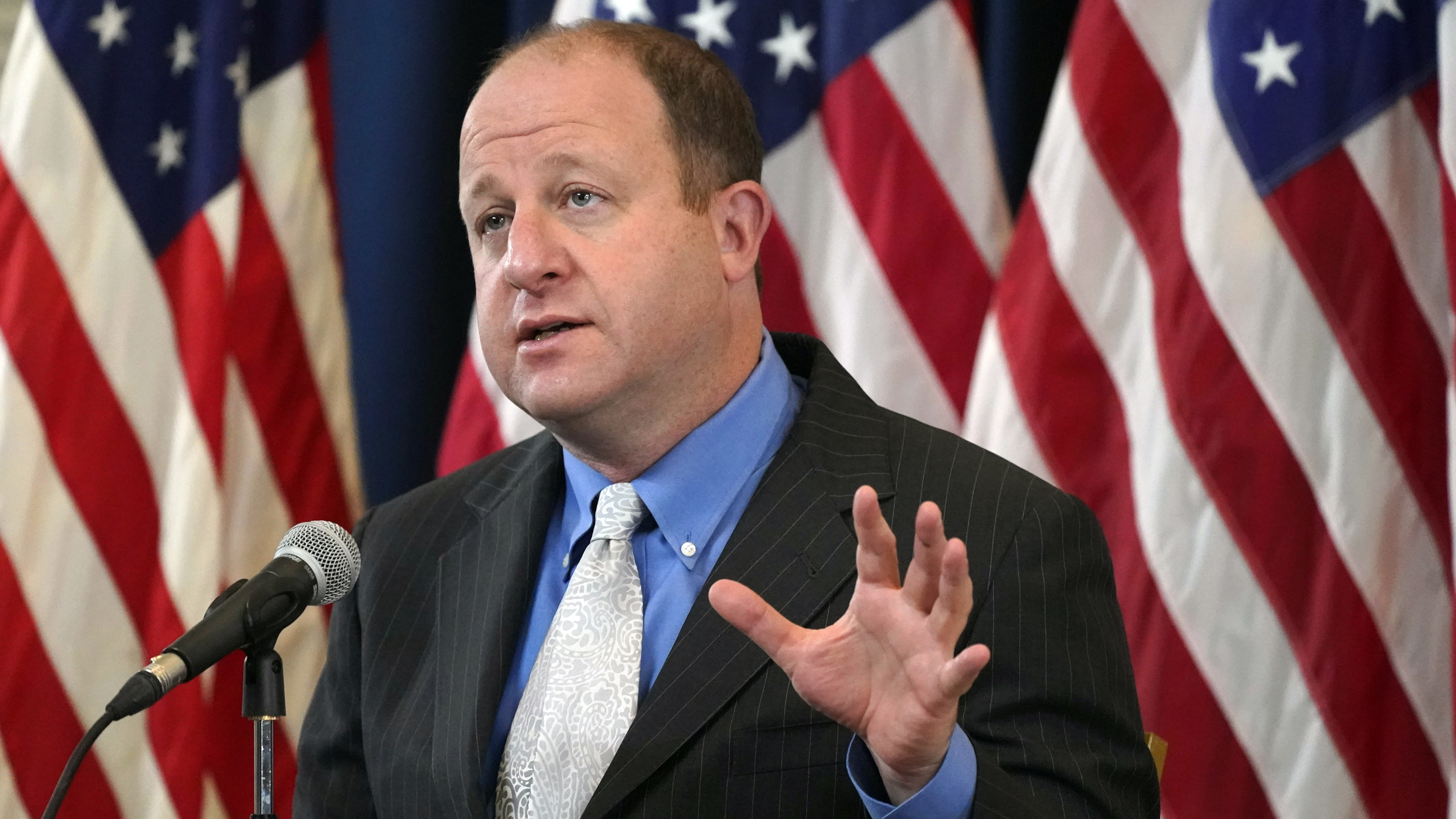 Colorado Gov. Jared Polis speaks during a news conference on Oct. 20 about the steady increase in new coronavirus cases in the state.