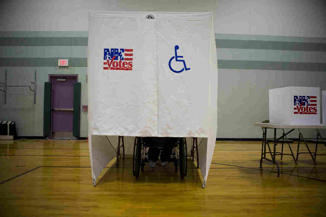An accessible voting booth is seen during the New Hampshire primary at a high school in Nashua, N.H. If voting with a disability, plan ahead and know your rights. And don't leave that polling place without casting your ballot.