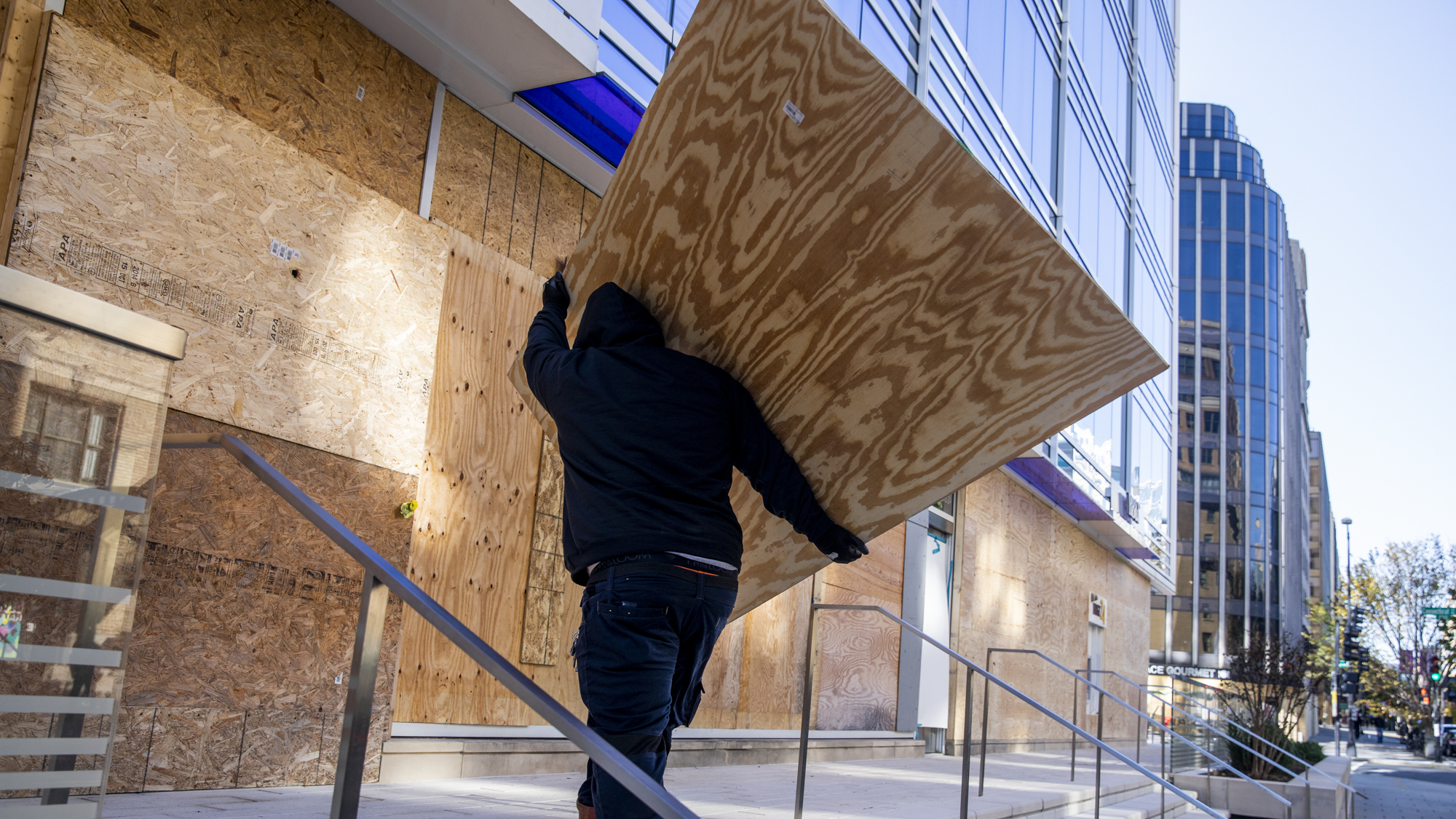 Workers board up a building in downtown Washington, D.C., in preparation for possible protests.