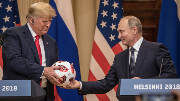 Russian President Vladimir Putin hands President Trump a World Cup soccer ball during a joint news conference after their summit on July 16, 2018, in Helsinki.