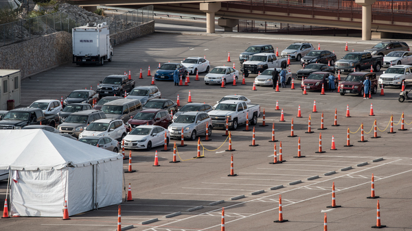 Cars wait in line at a coronavirus testing site at the University of Texas at El Paso Saturday. As El Paso reports record numbers of active coronavirus cases, the Texas attorney general sued to block local shutdown orders.
