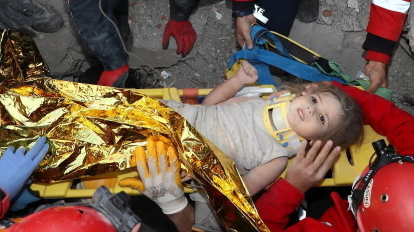 Rescue workers carry Ayda Gezgin away from the spot where she was trapped by rubble from a collapsed building after an earthquake in the Aegean port city of Izmir, Turkey.
