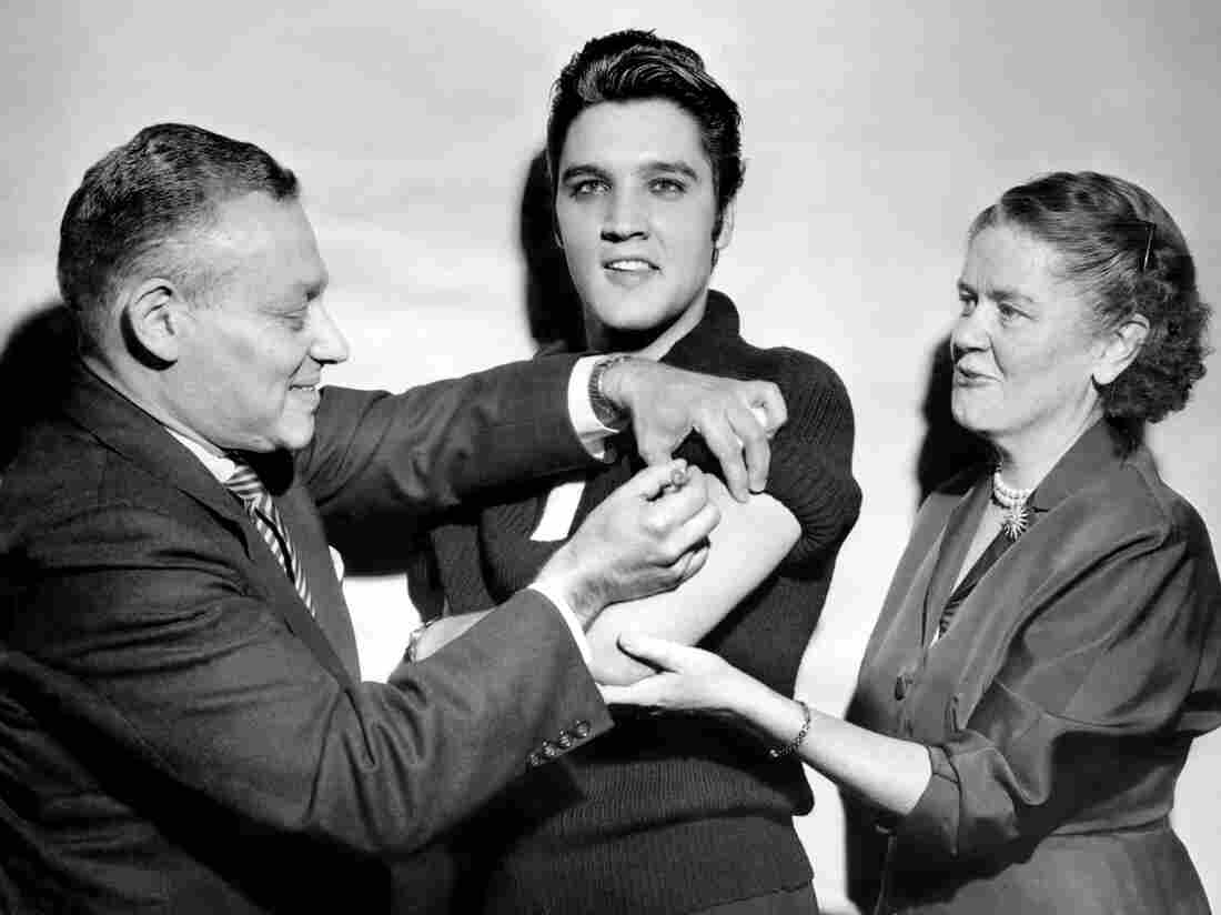 UNITED STATES - OCTOBER 28: Elvis Presley receiving a polio vaccination from Dr. Leona Baumgartner and Dr. Harold Fuerst at CBS studio 50 in New York City. (Photo by Seymour Wally/NY Daily News Archive via Getty Images)