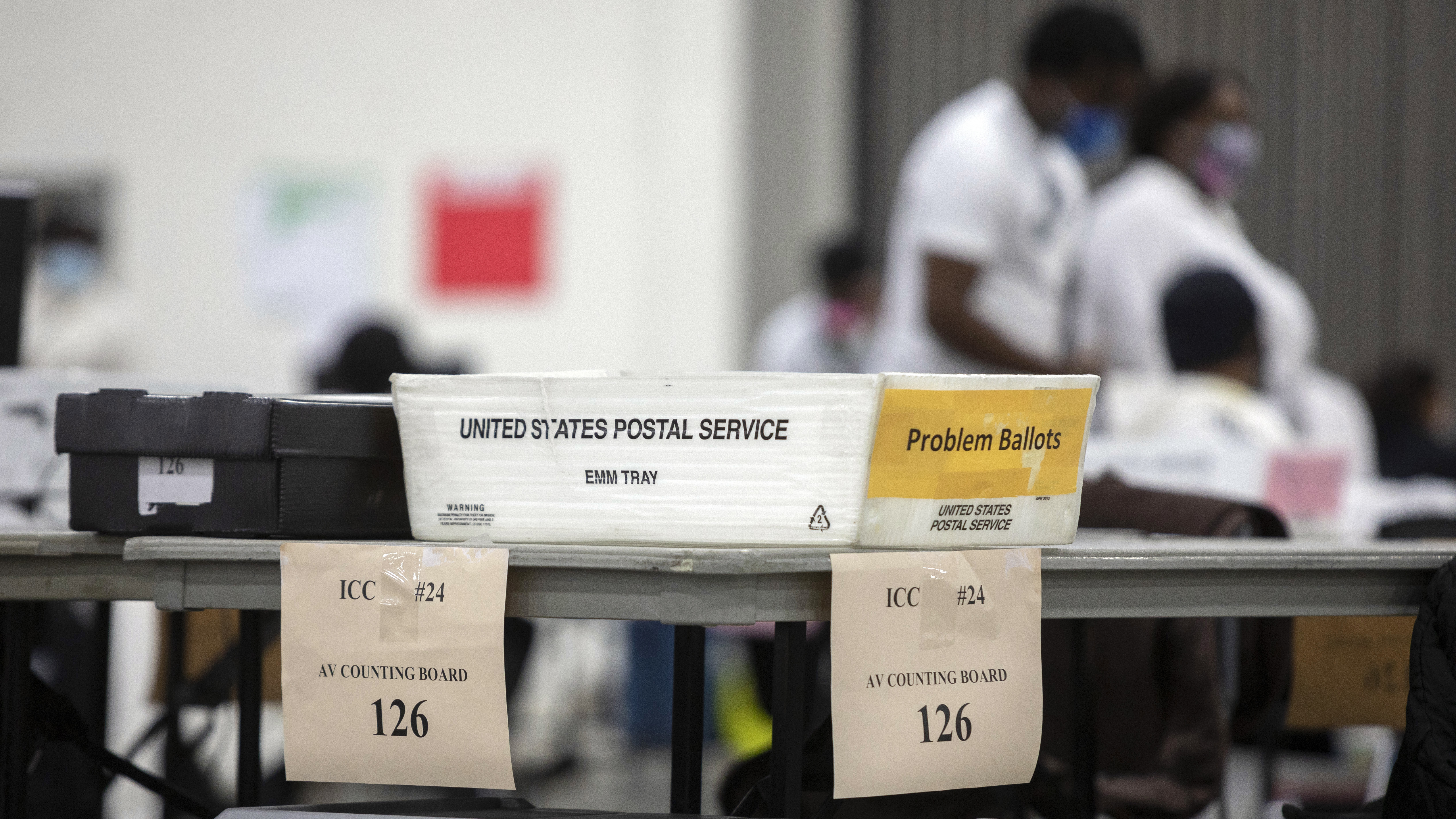 A problem ballot box is placed on the end of a table where workers with the Detroit Department of Elections sorts through absentee ballots.