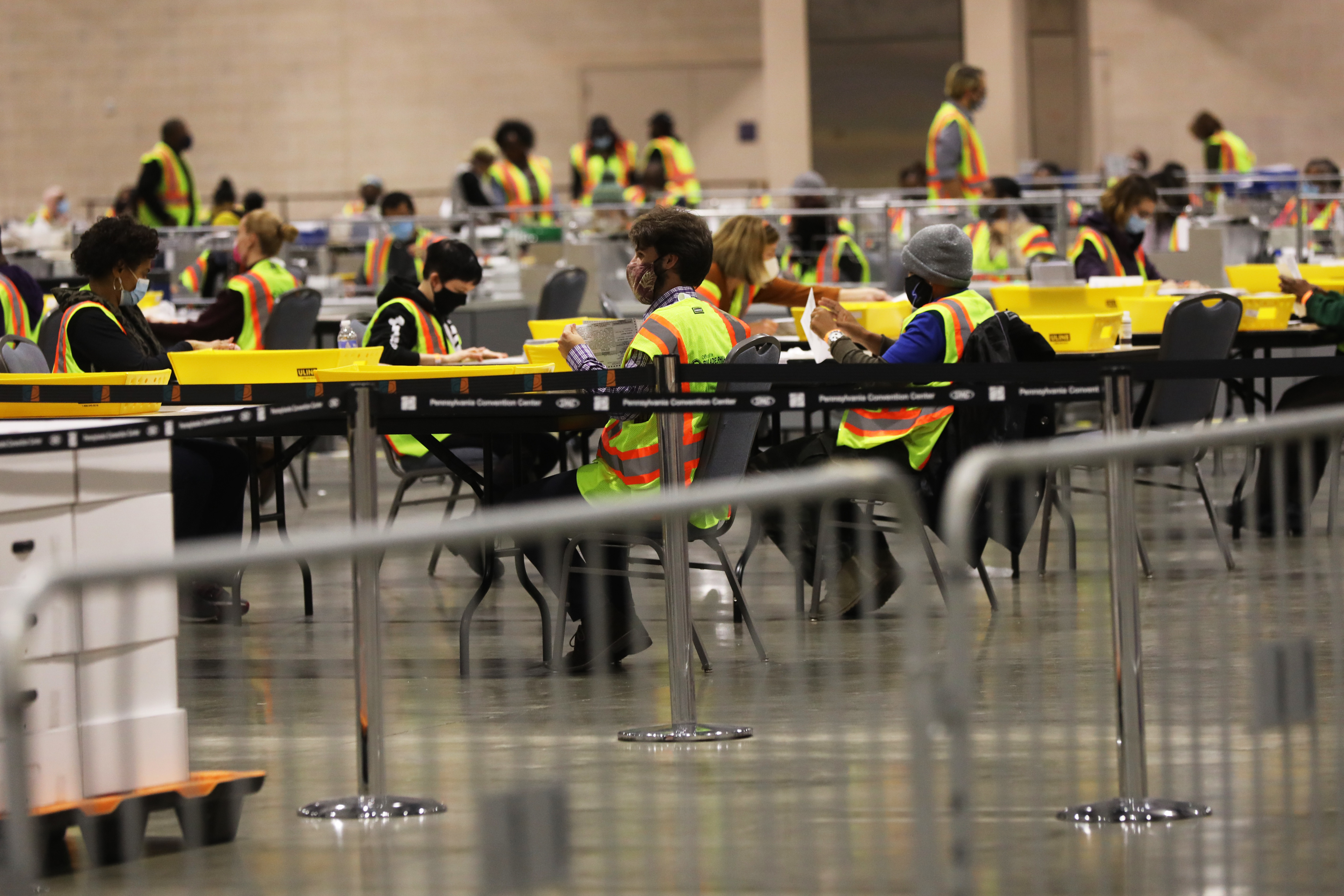 Election workers count ballots on November 3 in Philadelphia. While the election was logistically complicated and there were efforts by foreign and domestic actors to disrupt the election, it appears a record number of Americans cast ballots. (Getty Images)