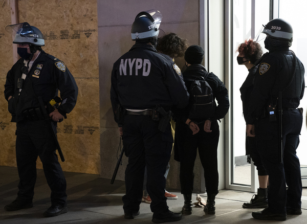 Police officers arrest some protesters in New York City on Wednesday. The department said there were 25 arrests.