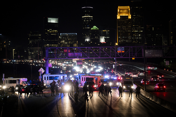 Police block traffic as demonstrators march on to highway I-94 on Wednesday in Minneapolis.