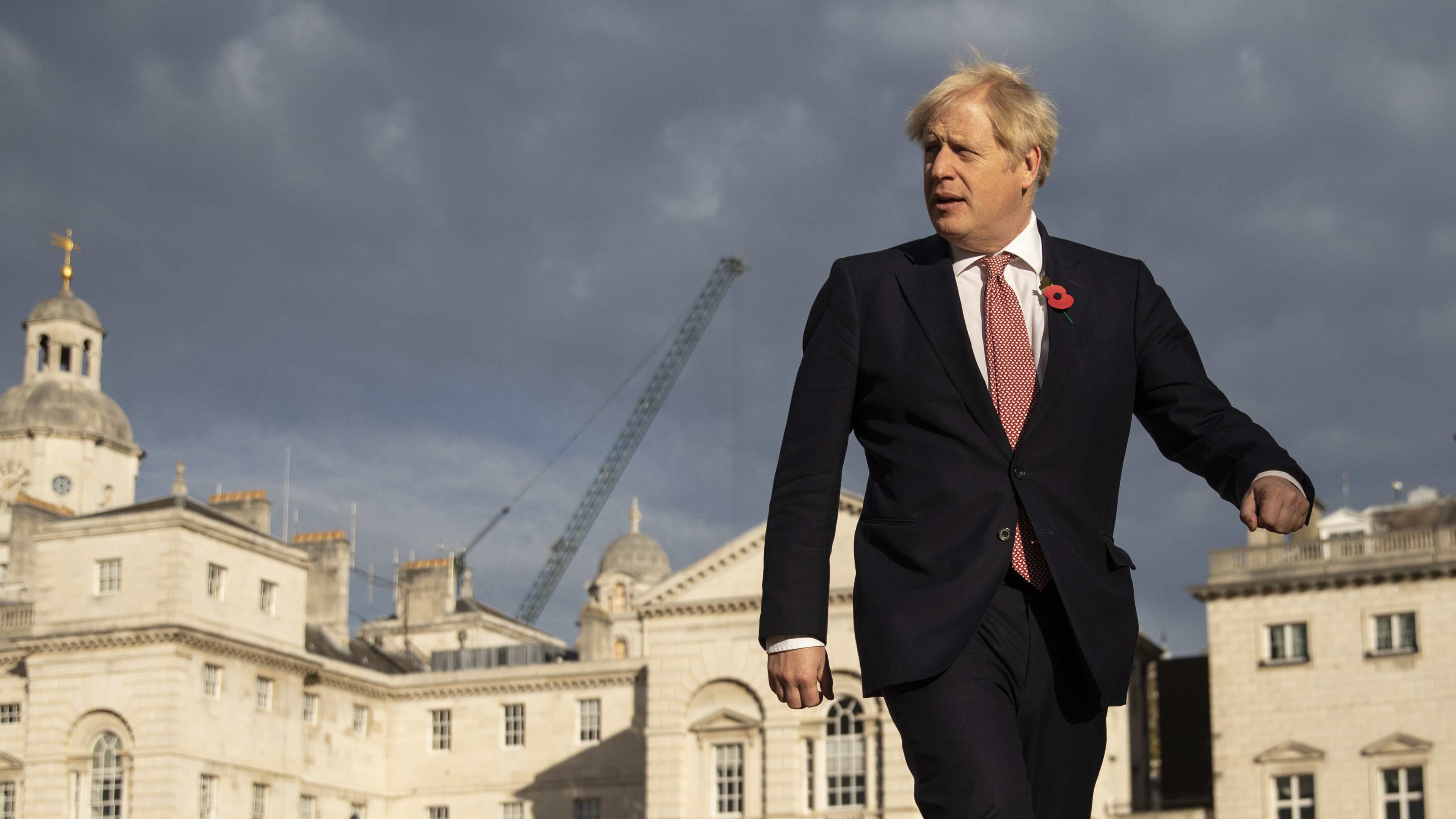 British Prime Minister Boris Johnson walks across Horse Guards Parade to Admiralty House on Friday in London.