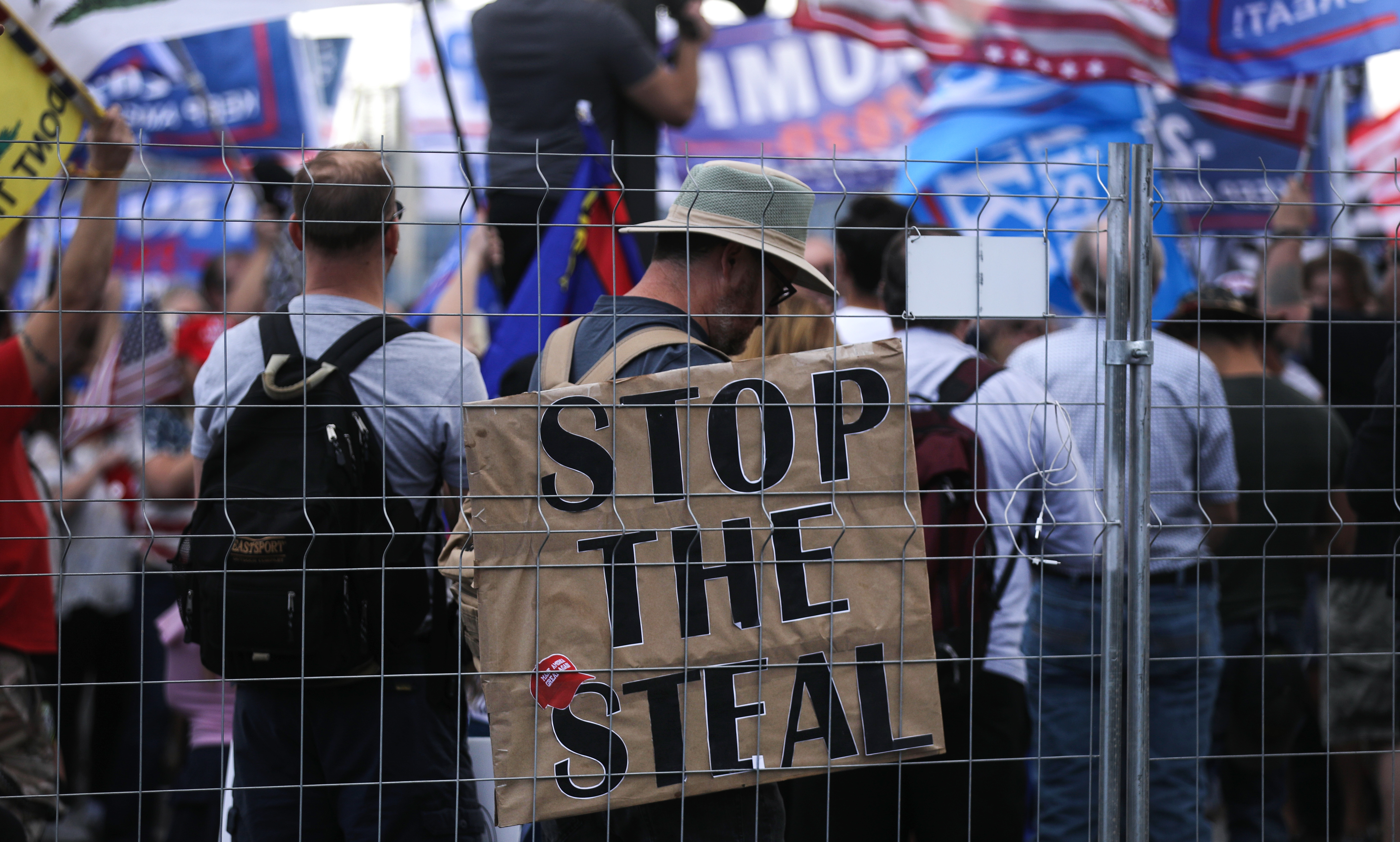 Supporters of President Trump demonstrate at a &quot;Stop the Steal&quot; rally in front of the Maricopa County Elections Department office in Phoenix on Saturday. Domestic terrorism analysts warn that a prolonged fight and Trump's statements about the vote only fuel polarization. (Getty Images)